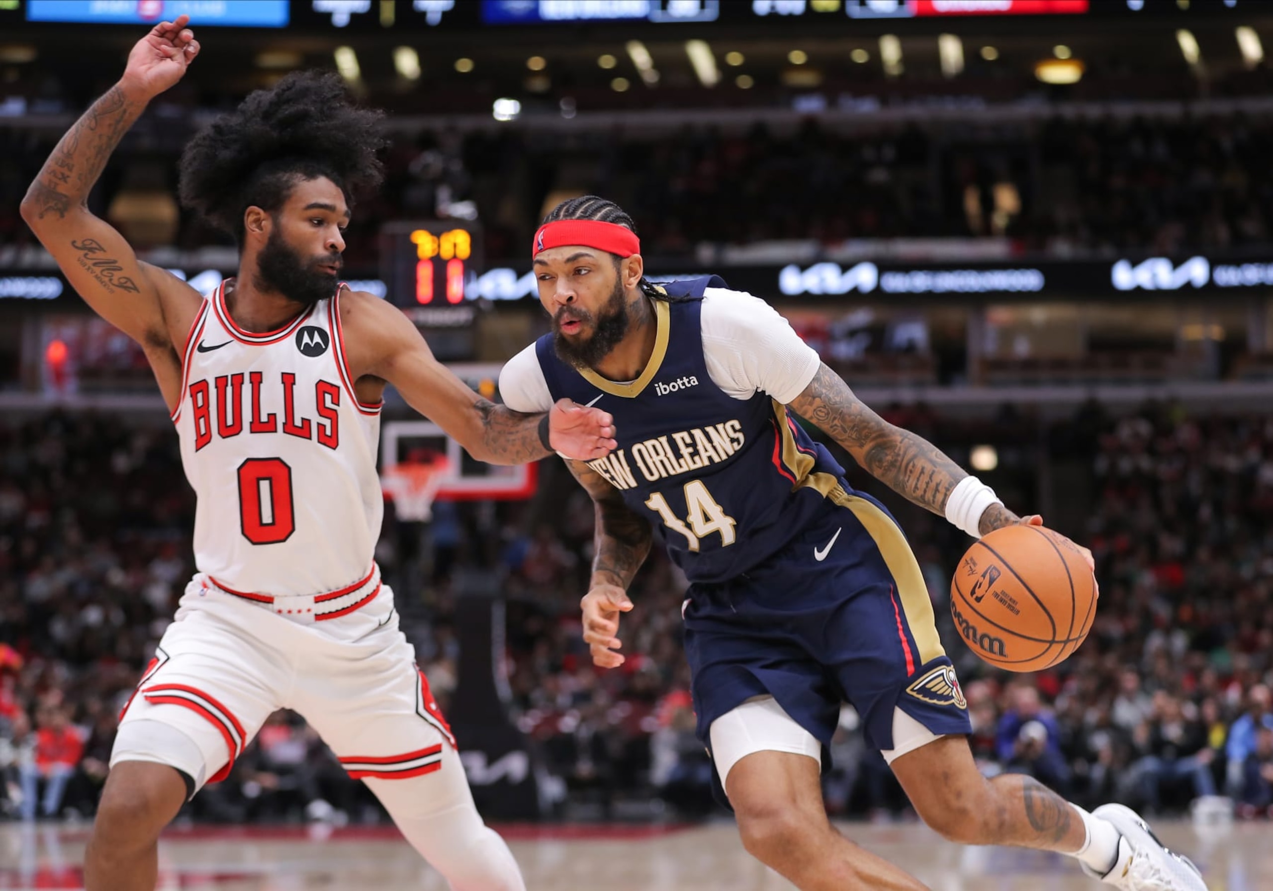 CHICAGO, IL - DECEMBER 02: Coby White #0 of the Chicago Bulls guards Brandon Ingram #14 of the New Orleans Pelicans during the first half at the United Center on December 2, 2023 in Chicago, Illinois. (Photo by Melissa Tamez/Icon Sportswire via Getty Images)