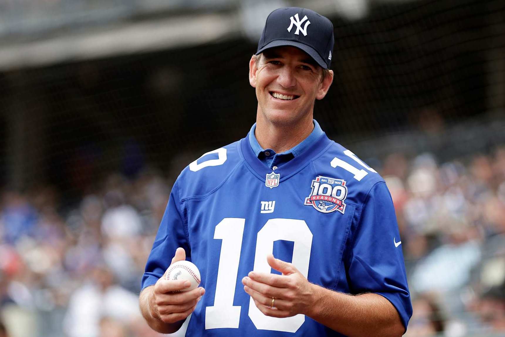 NEW YORK, NY - AUGUST 4: Former New York Giants quarterback Eli Manning smiles before throwing out a ceremonial first pitch at Yankee Stadium before the Toronto Blue Jays take on the New York Yankees on August 4, 2024 in New York City. (Photo by Adam Hunger/Getty Images)