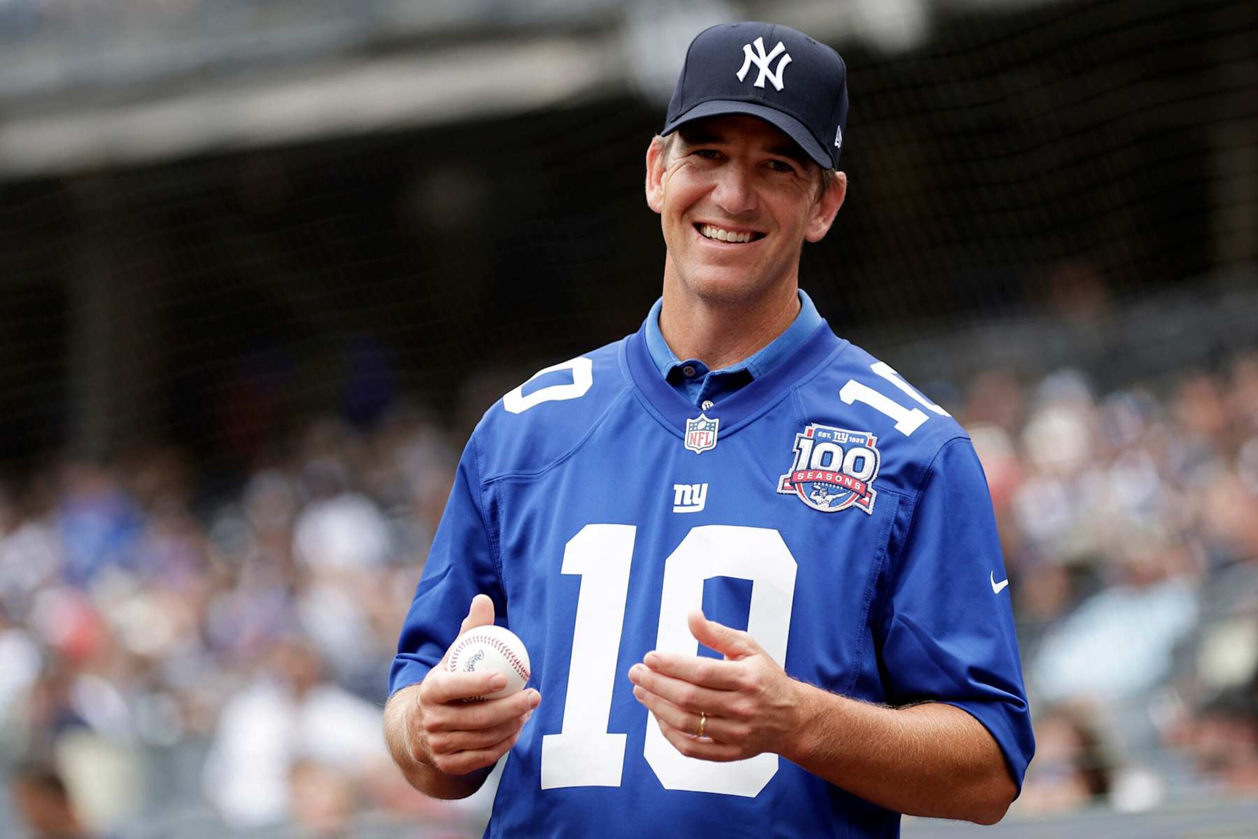 NEW YORK, NY - AUGUST 4: Former New York Giants quarterback Eli Manning smiles before throwing out a ceremonial first pitch at Yankee Stadium before the Toronto Blue Jays take on the New York Yankees on August 4, 2024 in New York City. (Photo by Adam Hunger/Getty Images) NEW YORK, NY - AUGUST 4: Former New York Giants quarterback Eli Manning smiles before throwing out a ceremonial first pitch at Yankee Stadium before the Toronto Blue Jays take on the New York Yankees on August 4, 2024 in New York City. (Photo by Adam Hunger/Getty Images)