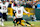 GREEN BAY, WISCONSIN - JANUARY 05: Caleb Williams #18 of the Chicago Bears throws a pass while being tackled by Edgerrin Cooper #56 of the Green Bay Packers in the fourth quarter at Lambeau Field on January 05, 2025 in Green Bay, Wisconsin. (Photo by Patrick McDermott/Getty Images)