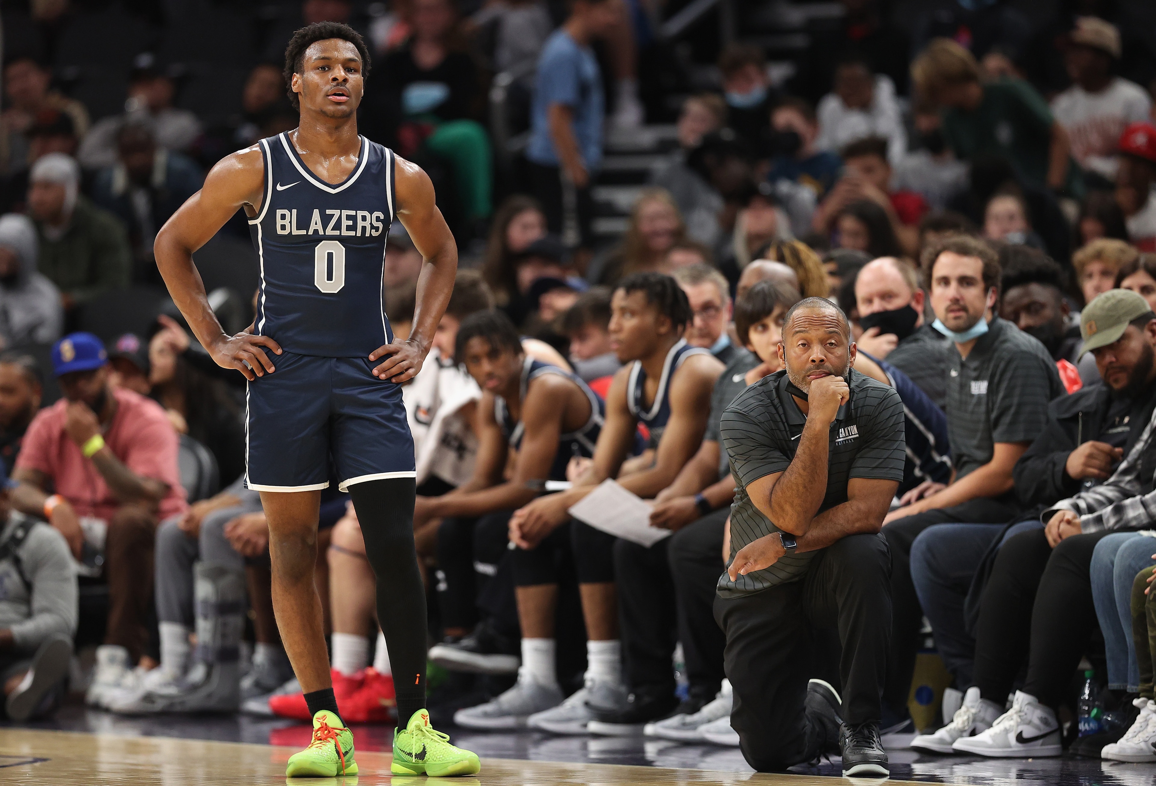 PHOENIX, ARIZONA - DECEMBER 11: Bronny James #0 and head coach Andre Chevalier of the Sierra Canyon Trailblazers look on during the Hoophall West tournament against the Perry Pumas at Footprint Center on December 11, 2021 in Phoenix, Arizona. (Photo by Christian Petersen/Getty Images)