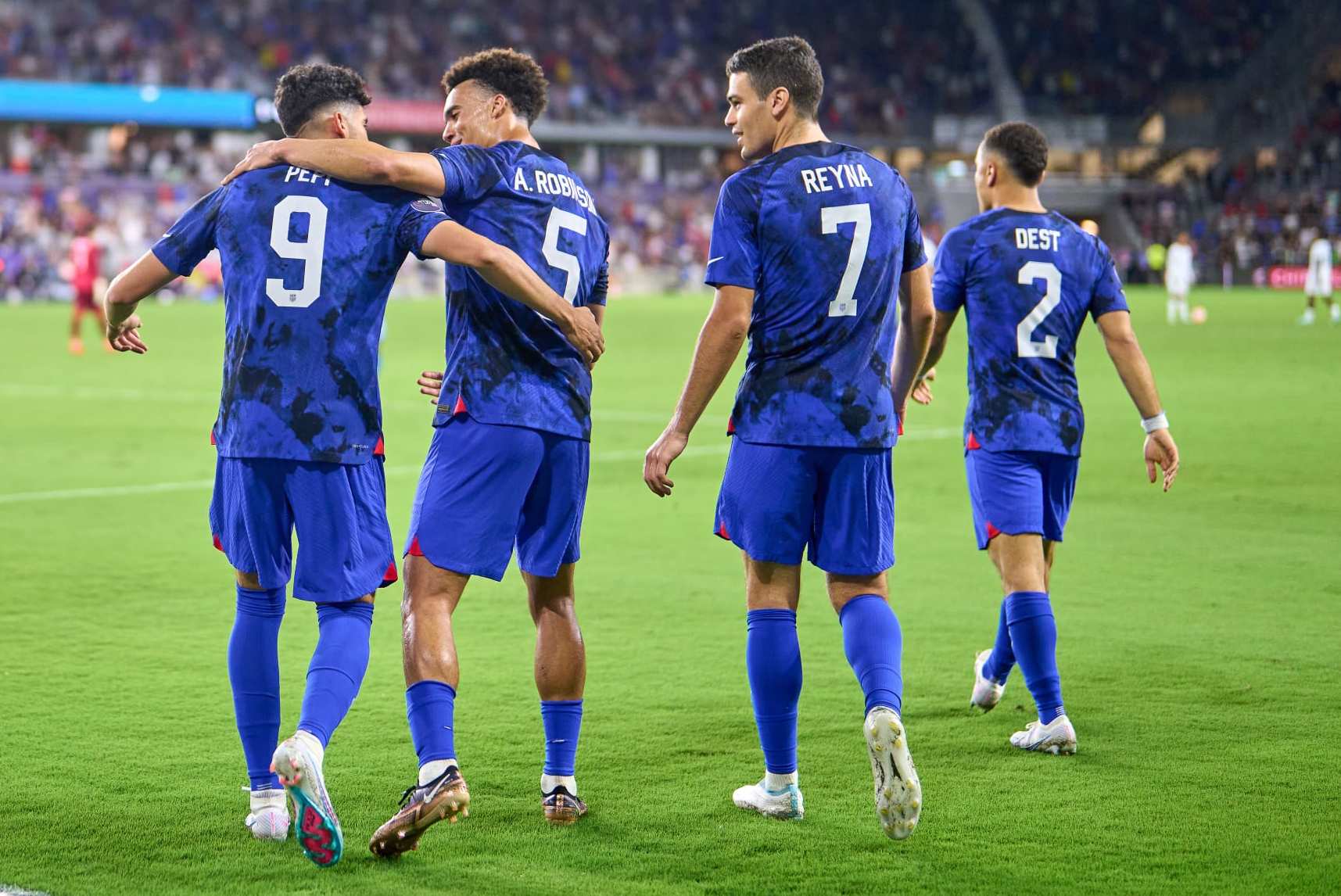 ORLANDO, FL - MARCH 27: Ricardo Pepi #9 of the United States celebrates scoring with teammates including Antonee Robinson #5, Sergino Dest #2 and Gio Reyna #7 during a game between El Salvador and USMNT at Exploria Stadium on March 27, 2023 in Orlando, Florida. (Photo by Robin Alam/ISI Photos/Getty Images)