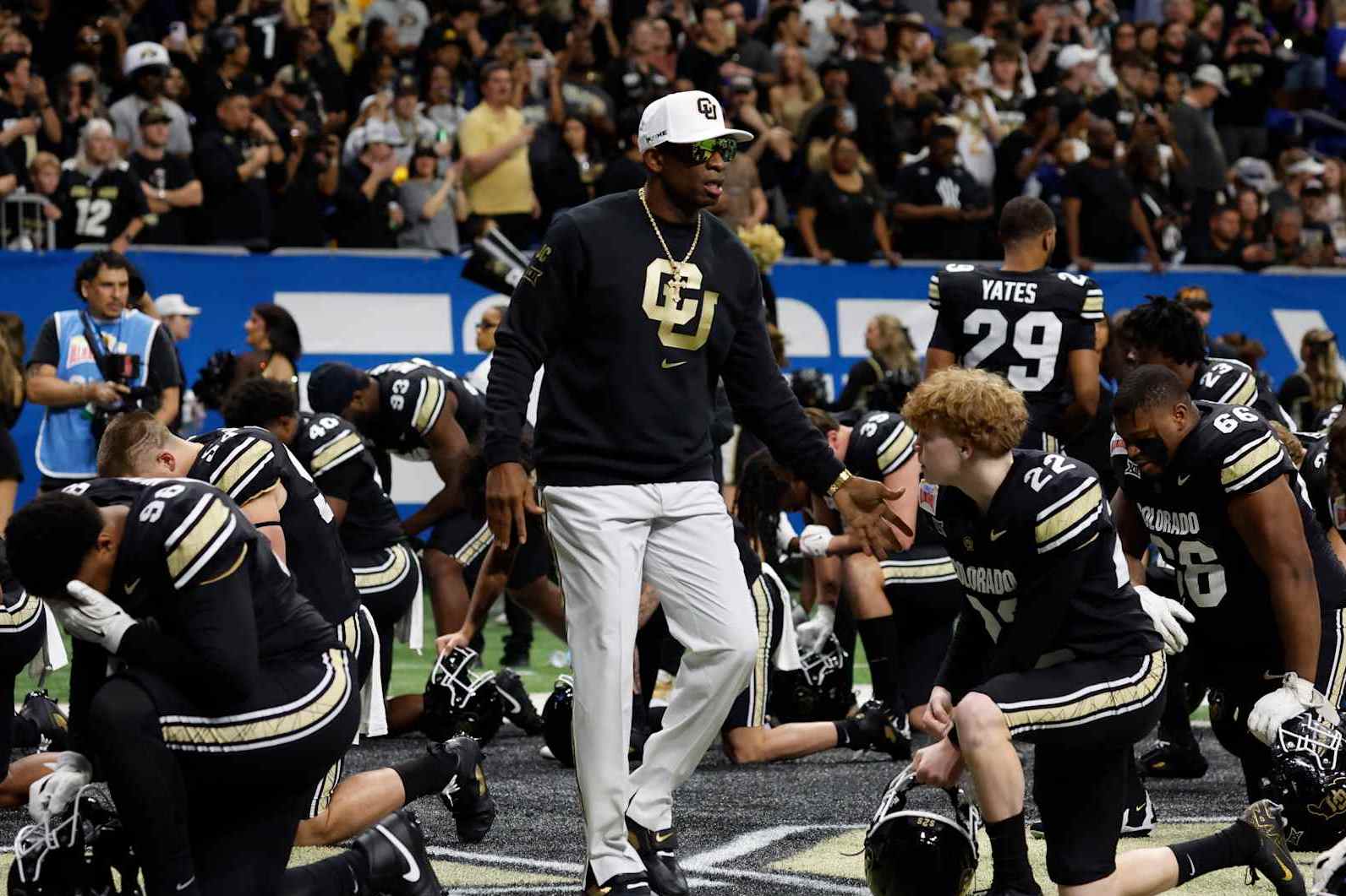 SAN ANTONIO, TX - DECEMBER 28:  Deion Sanders head coach of the Colorado Buffaloes greets his team before the start of their game against the BYU Cougars in the Valero Alamo Bowl at Alamodome on December 28, 2024 in San Antonio, Texas. (Photo by Ronald Cortes/Getty Images)