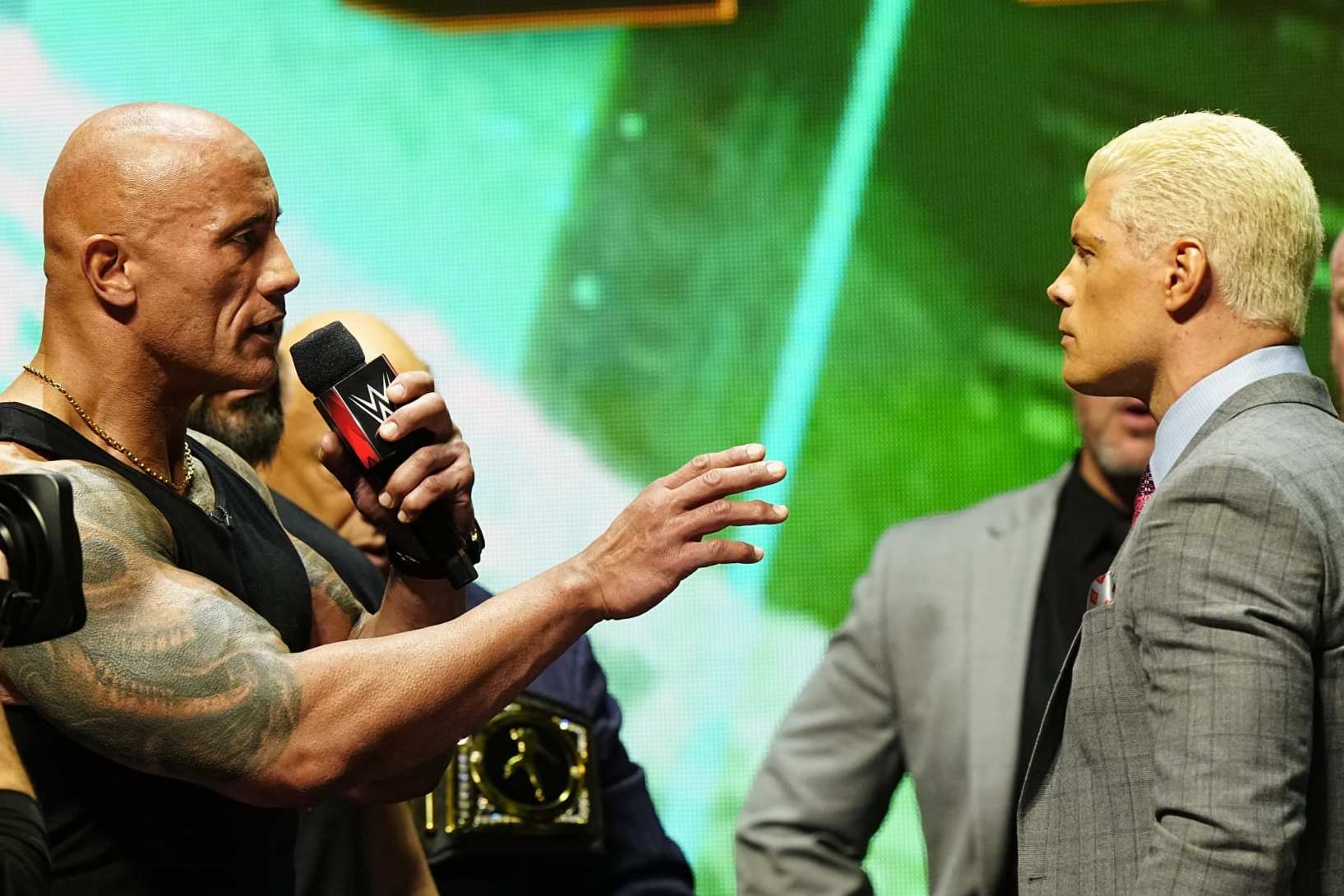 LAS VEGAS, NV - FEBRUARY 08:  Dwayne "The Rock" Johnson and Cody Rhodes face-off on stage during the WWE Wrestlemania XL Kickoff on February 08, 2024, at T-Mobile Arena in Las Vegas, NV. (Photo by Louis Grasse/PXimages/Icon Sportswire via Getty Images)