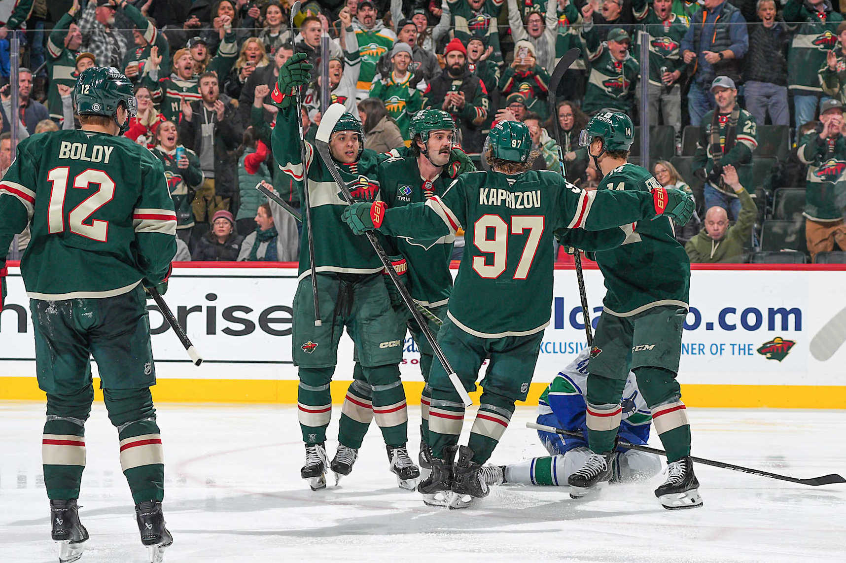 SAINT PAUL, MN - DECEMBER 3: Jake Middleton #5 celebrates his goal with his teammates Brock Faber #7, Kirill Kaprizov #97, Joel Eriksson Ek #14 and Matt Boldy #12 of the Minnesota Wild against the Vancouver Canucks during the game at the Xcel Energy Center on December 3, 2024 in Saint Paul, Minnesota. (Photo by Bruce Kluckhohn/NHLI via Getty Images)