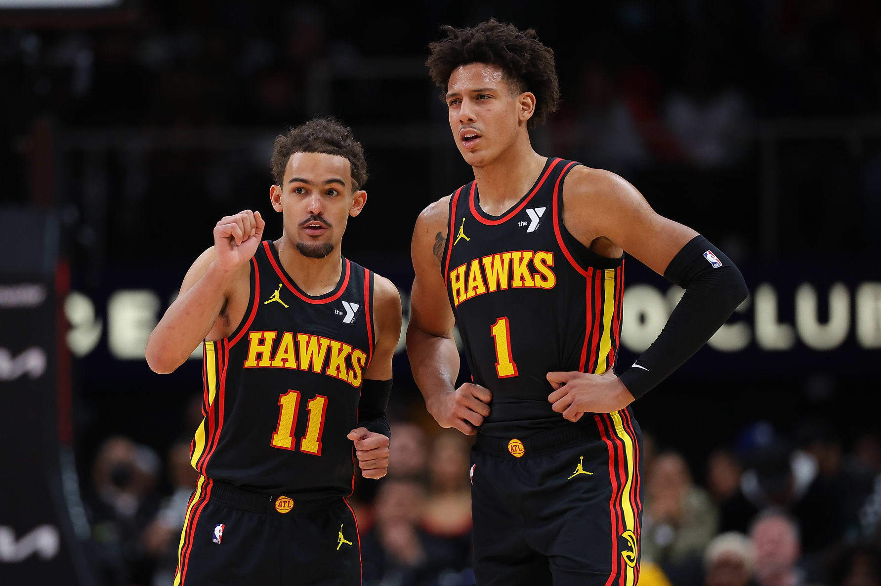 ATLANTA, GEORGIA - FEBRUARY 05:  Trae Young #11 and Jalen Johnson #1 of the Atlanta Hawks converse against the LA Clippers during the second quarter at State Farm Arena on February 05, 2024 in Atlanta, Georgia.  NOTE TO USER: User expressly acknowledges and agrees that, by downloading and/or using this photograph, user is consenting to the terms and conditions of the Getty Images License Agreement.  (Photo by Kevin C. Cox/Getty Images)