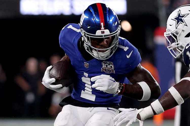 EAST RUTHERFORD, NEW JERSEY - SEPTEMBER 26: Malik Nabers #1 of the New York Giants carries the ball while DeMarvion Overshown #13 of the Dallas Cowboys attempts a tackle during the second quarter at MetLife Stadium on September 26, 2024 in East Rutherford, New Jersey. (Photo by Sarah Stier/Getty Images)