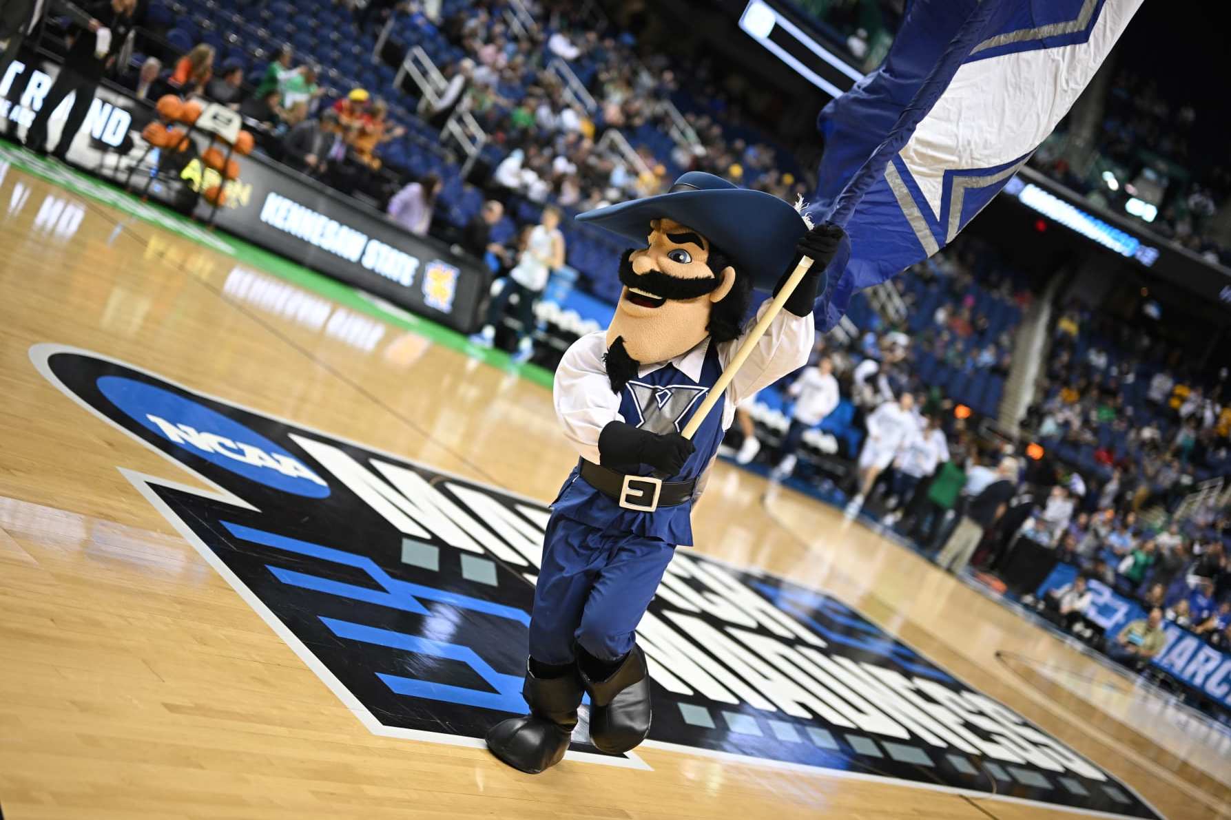 GREENSBORO, NC - MARCH 17: The Xavier Musketeers mascot leads the team onto the field before taking on the Kennesaw State Owls during the first round of the 2023 NCAA Men's Basketball Tournament held at Greensboro Coliseum on March 17, 2023 in Greensboro, North Carolina. (Photo by John Joyner/NCAA Photos via Getty Images)