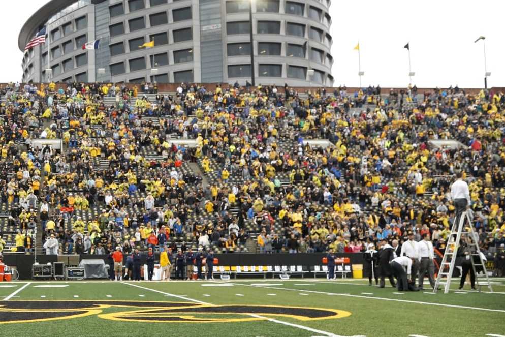 FILE - Atlanta Falcons defensive end and former University of Iowa player Adrian Clayborn, left, and Kid Captain Maddox Smith are honored on the field before an NCAA college football game between Iowa and Illinois in Iowa City, Iowa, Oct. 7, 2017. "The Wave" at Iowa home games, where fans salute children from the nearby hospital battling cancer and their families, has become college football's neatest new tradition. The University of Iowa announced that patients at UI Stead Family Children's Hospital will get to pick the songs that accompany the Hawkeye Wave, at which fans attending games at Iowa's Kinnick Stadium wave to patients at the adjacent hospital. Now at every Iowa home game this year, the hospital's Kid Captain — a Children's Hospital patient who is is picked to be honored at each Iowa football game — will help select a new song to accompany the Hawkeye Wave. (AP Photo/Charlie Neibergall, File)