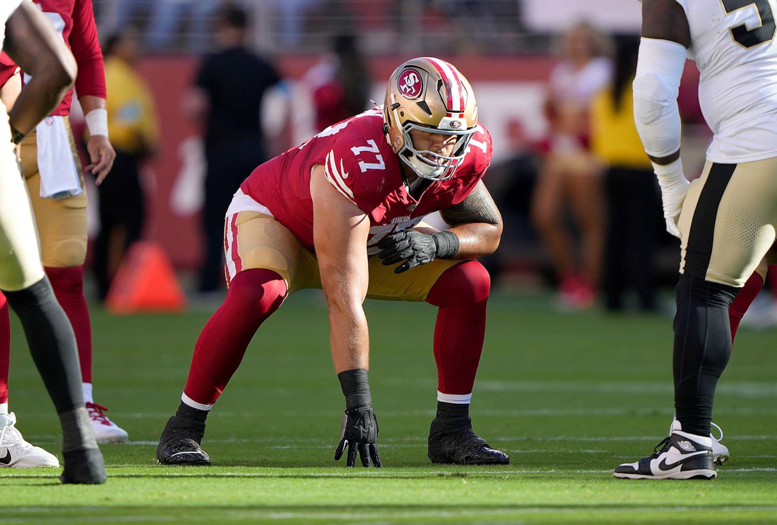 SANTA CLARA, CALIFORNIA - AUGUST 18: Dominick Puni #77 of the San Francisco 49ers pass blocks against Khalen Saunders #50 the New Orleans Saints during the first half of a preseason game at Levi's Stadium on August 18, 2024 in Santa Clara, California. (Photo by Thearon W. Henderson/Getty Images) SANTA CLARA, CALIFORNIA - AUGUST 18: Dominick Puni #77 of the San Francisco 49ers pass blocks against Khalen Saunders #50 the New Orleans Saints during the first half of a preseason game at Levi's Stadium on August 18, 2024 in Santa Clara, California. (Photo by Thearon W. Henderson/Getty Images)