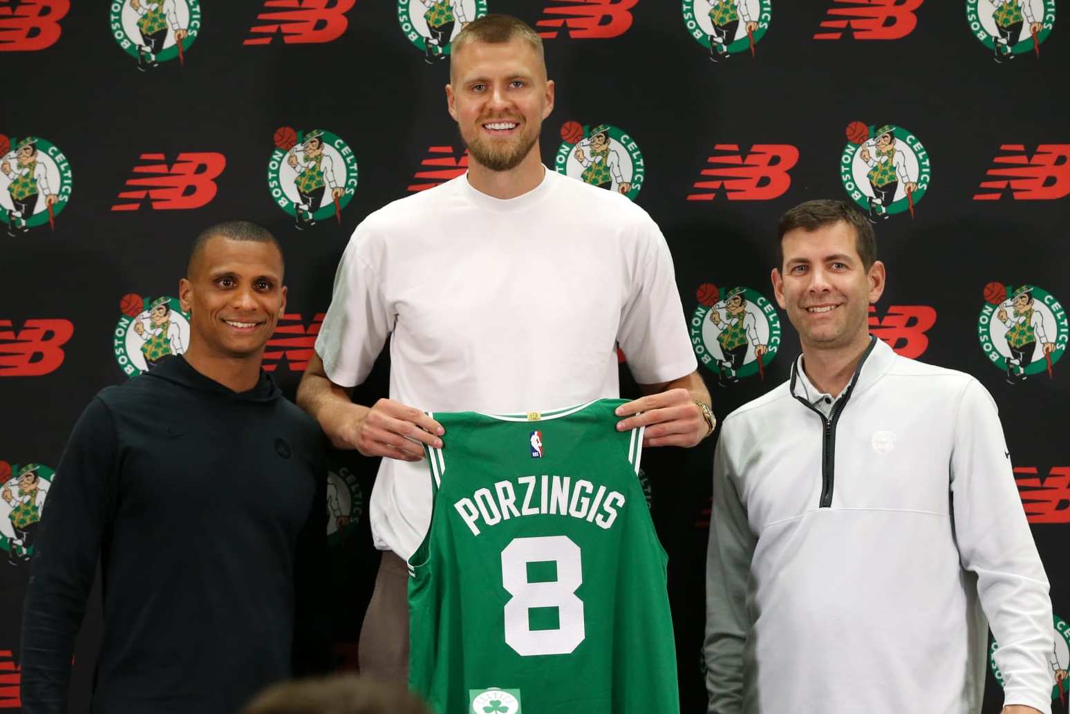Boston, MA - June 29: Boston Celtics C Kristaps Porzingis holds up his number eight Celtics jersey at his introductory press conference, flanked by head coach Joe Mazzulla and President of Basketball Operations Brad Stevens. (Photo by Jonathan Wiggs/The Boston Globe via Getty Images) Boston, MA - June 29: Boston Celtics C Kristaps Porzingis holds up his number eight Celtics jersey at his introductory press conference, flanked by head coach Joe Mazzulla and President of Basketball Operations Brad Stevens. (Photo by Jonathan Wiggs/The Boston Globe via Getty Images)