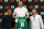 Boston, MA - June 29: Boston Celtics C Kristaps Porzingis holds up his number eight Celtics jersey at his introductory press conference, flanked by head coach Joe Mazzulla and President of Basketball Operations Brad Stevens. (Photo by Jonathan Wiggs/The Boston Globe via Getty Images)