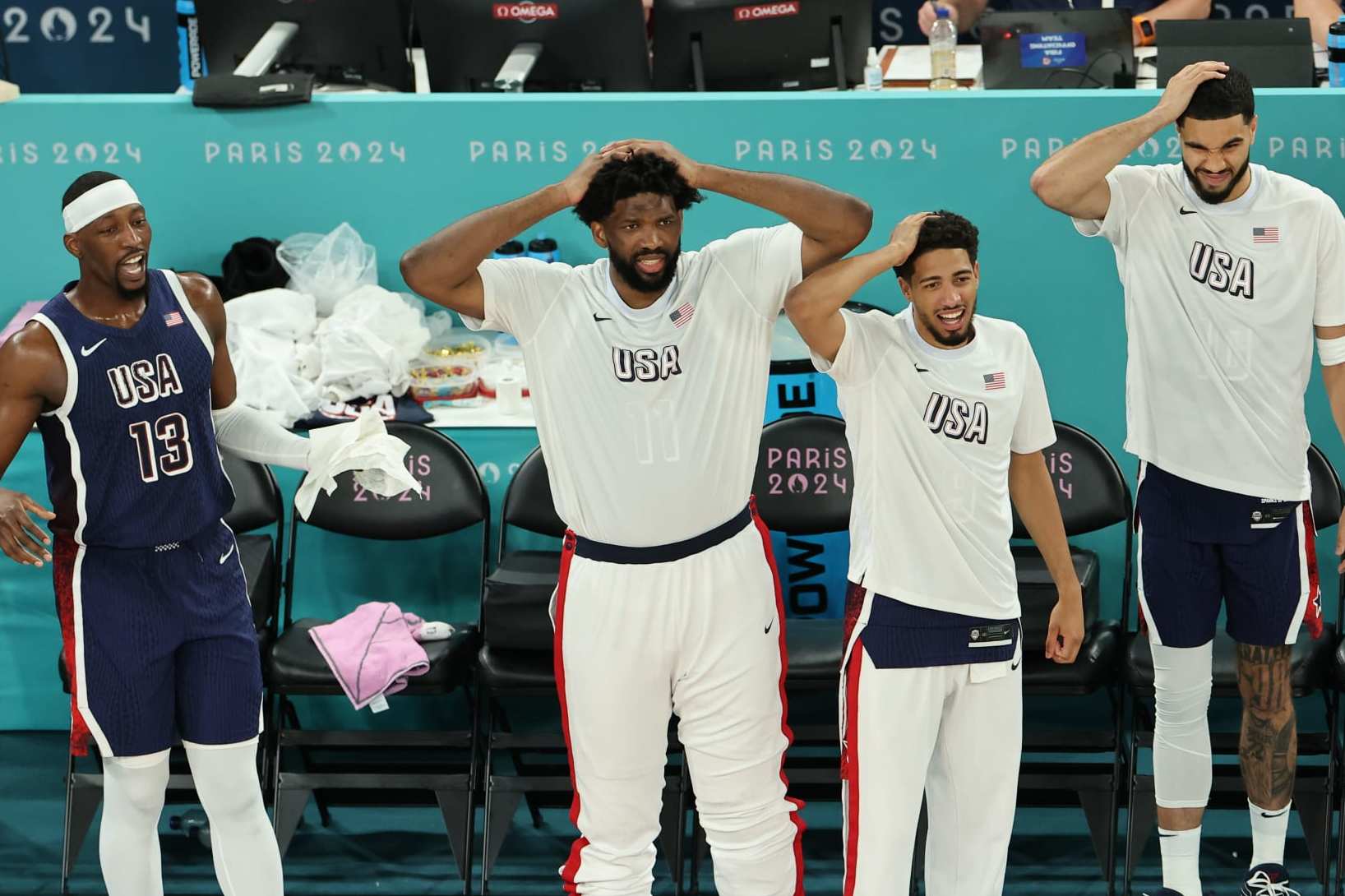 PARIS, FRANCE - AUGUST 06: Bam Adebayo #13, Joel Embiid #11, Tyrese Haliburton #9, and Jayson Tatum #10 of Team United States react from the bench during a Men's basketball quarterfinal game between Team United States and Team Brazil on day eleven of the Olympic Games Paris 2024 at Bercy Arena on August 06, 2024 in Paris, France. (Photo by Arturo Holmes/Getty Images)