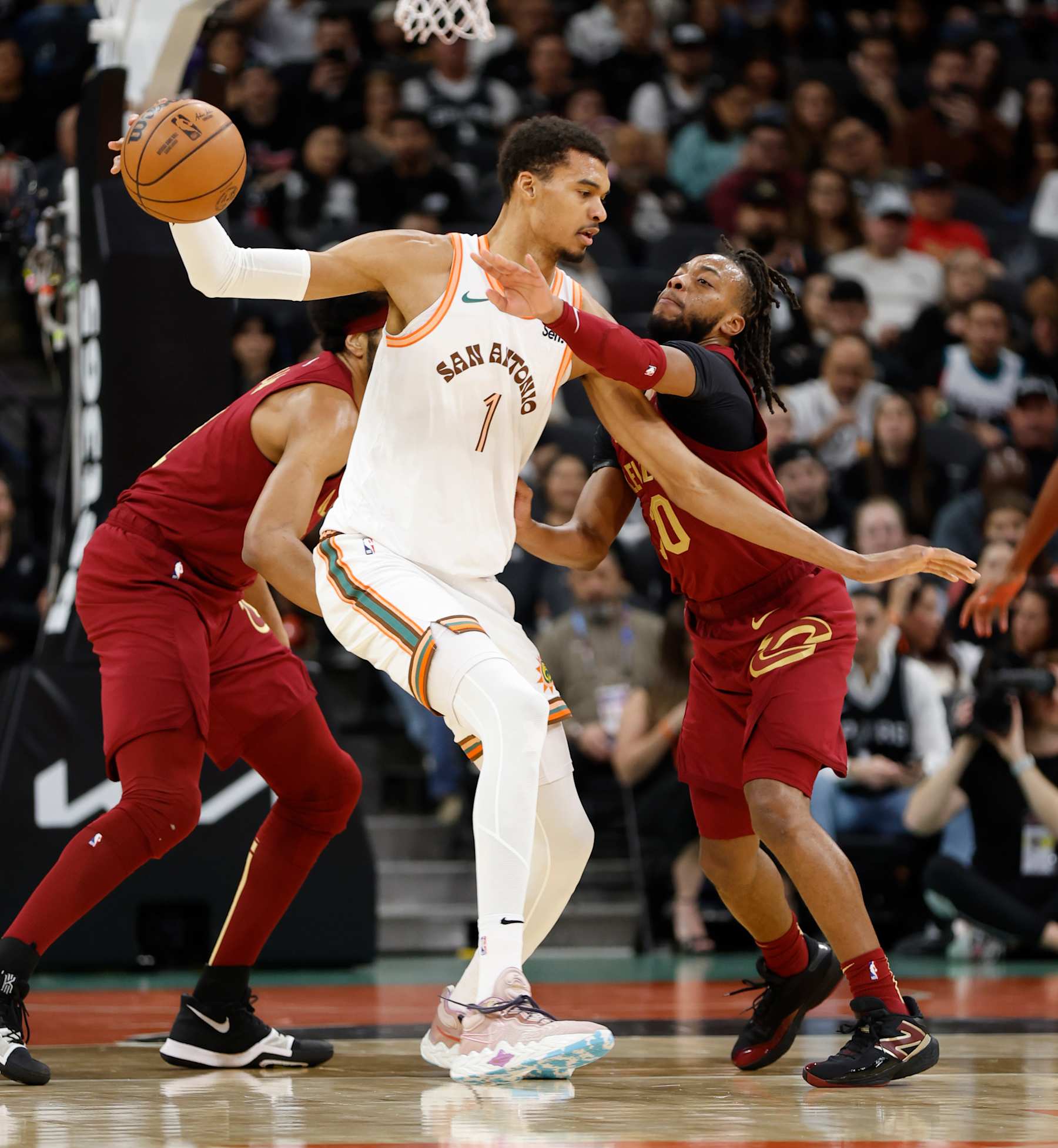 SAN ANTONIO, TX - FEBRUARY 03: Victor Wembanyama #1 of the San Antonio Spurs keeps the ball away from Darius Garland #21 of the Cleveland Cavaliers in the first half at Frost Bank Center on February 3, 2024 in San Antonio, Texas. NOTE TO USER: User expressly acknowledges and agrees that, by downloading and or using this photograph, User is consenting to terms and conditions of the Getty Images License Agreement. (Photo by Ronald Cortes/Getty Images)