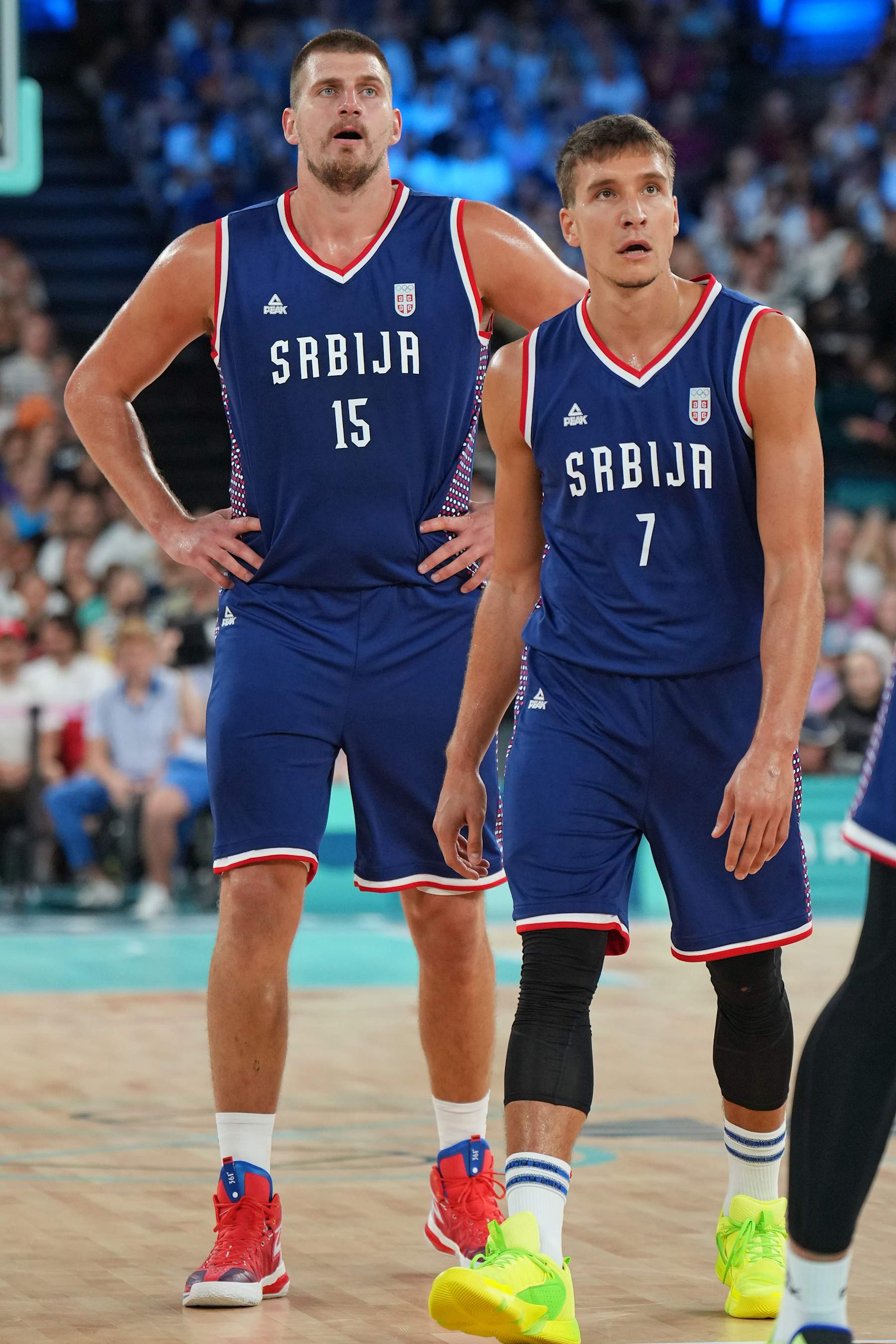 PARIS, FRANCE - AUGUST 10: Nikola Jokic #15  and Bogdan Bogdanovic #7 of the Serbian Men's National Team looks on during the game during the Men's Bronze Medal Game on August 10, 2024 at the AccorHotels Arena in Paris, France. NOTE TO USER: User expressly acknowledges and agrees that, by downloading and/or using this photograph, user is consenting to the terms and conditions of the Getty Images License Agreement. Mandatory Copyright Notice: Copyright 2024 NBAE (Photo by Jesse D. Garrabrant/NBAE via Getty Images)  