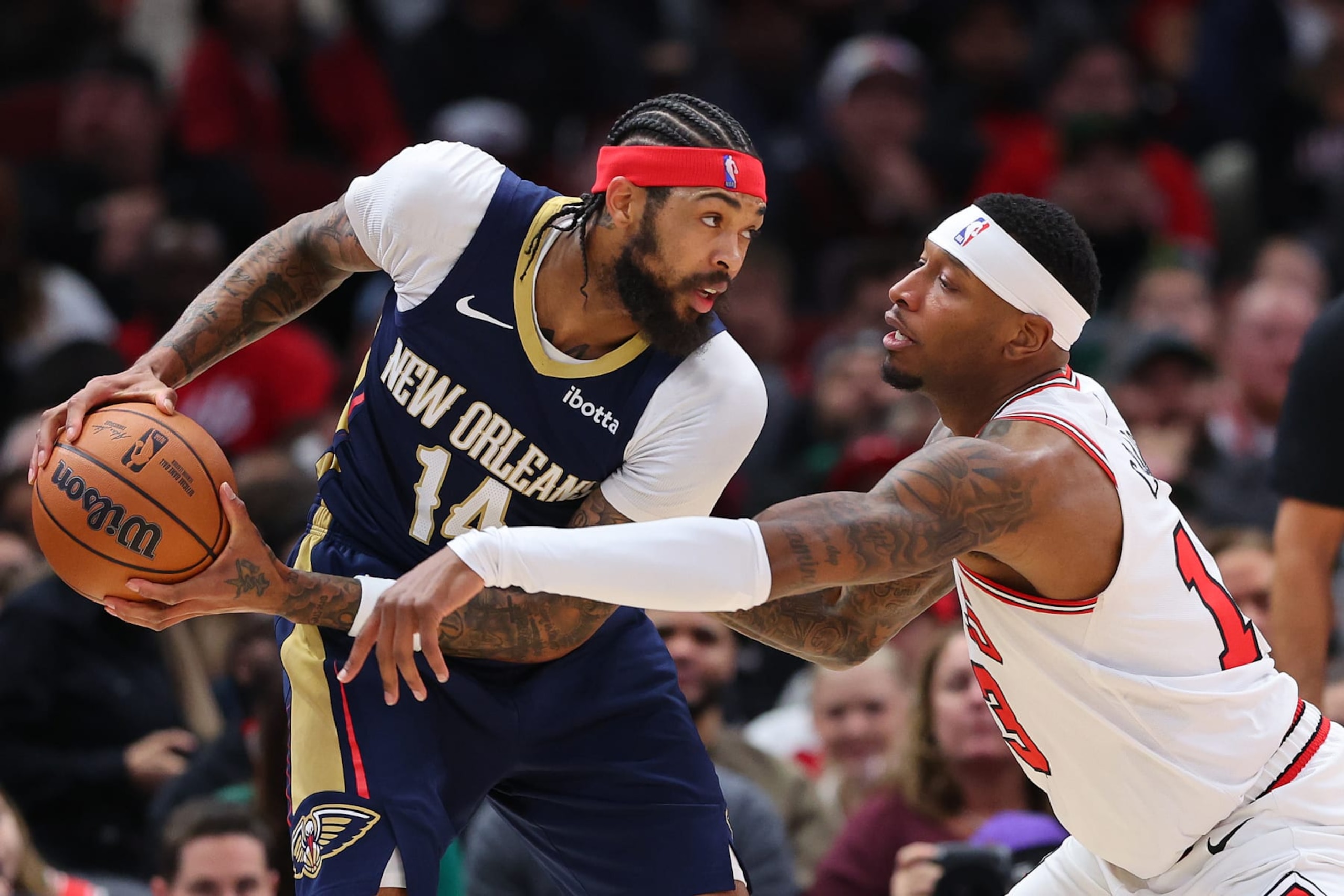 CHICAGO, ILLINOIS - DECEMBER 02: Brandon Ingram #14 of the New Orleans Pelicans is defended by Torrey Craig #13 of the Chicago Bulls during the first half at the United Center on December 02, 2023 in Chicago, Illinois. NOTE TO USER: User expressly acknowledges and agrees that, by downloading and or using this photograph, User is consenting to the terms and conditions of the Getty Images License Agreement.  (Photo by Michael Reaves/Getty Images)