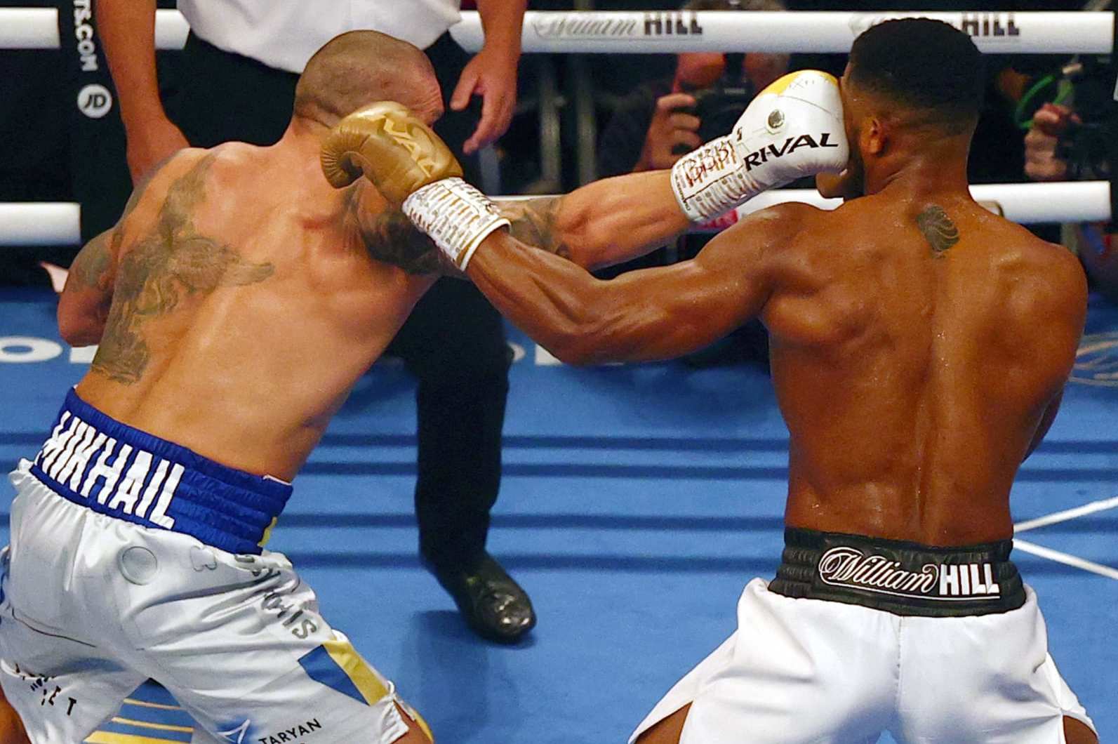 Ukrainian boxer Oleksandr Usyk (L) lands a punch against British heavyweight champion boxer Anthony Joshua during their heavyweight boxing match at Tottenham Hotspur Stadium in north London on September 25, 2021, as Joshua defends his WBA, IBF and WBO heavyweight titles. (Photo by Adrian DENNIS / AFP) (Photo by ADRIAN DENNIS/AFP via Getty Images)