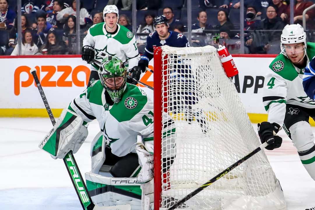 WINNIPEG, CANADA - NOVEMBER 11: Morgan Barron #36 of the Winnipeg Jets plays the puck around the net as goaltender Scott Wedgewood #41 and Miro Heiskanen #4 of the Dallas Stars defend during second period action at the Canada Life Centre on November 11, 2023 in Winnipeg, Manitoba, Canada. (Photo by Darcy Finley/NHLI via Getty Images)