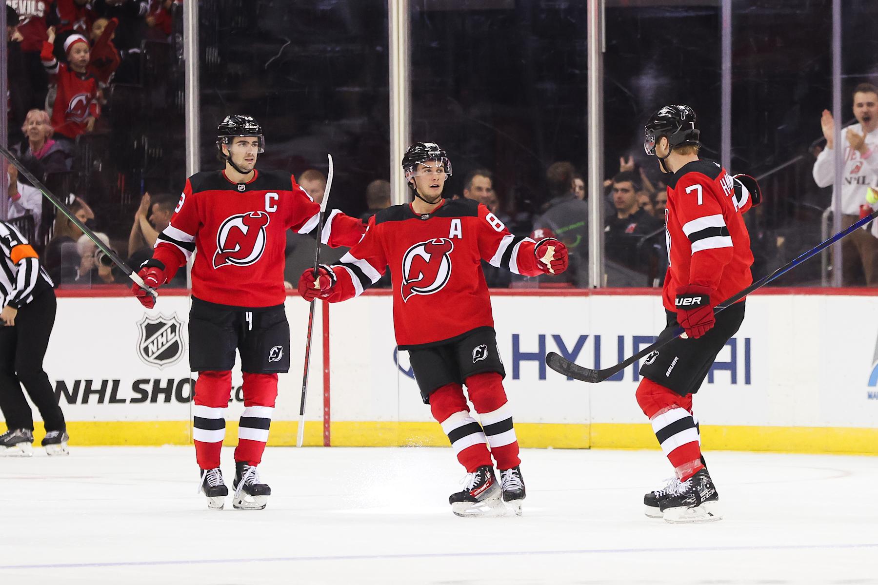 NEWARK, NJ - OCTOBER 13: New Jersey Devils defenseman Dougie Hamilton (7) celebrates with New Jersey Devils center Jack Hughes (86) and New Jersey Devils center Nico Hischier (13) after scoring a goal during a game between the Arizona Coyotes and New Jersey Devils on October 13, 2023 at Prudential Center in the Newark, New Jersey.(Photo by Andrew Mordzynski/Icon Sportswire via Getty Images) NEWARK, NJ - OCTOBER 13: New Jersey Devils defenseman Dougie Hamilton (7) celebrates with New Jersey Devils center Jack Hughes (86) and New Jersey Devils center Nico Hischier (13) after scoring a goal during a game between the Arizona Coyotes and New Jersey Devils on October 13, 2023 at Prudential Center in the Newark, New Jersey.(Photo by Andrew Mordzynski/Icon Sportswire via Getty Images)