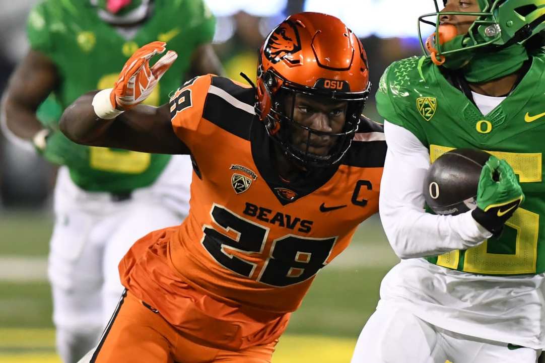 EUGENE, OR - NOVEMBER 24: Oregon Ducks wide receiver Tez Johnson (15) runs after the catch against Oregon State Beavers defensive back Kitan Oladapo (28) during a college football game between the Oregon Ducks and Oregon State Beavers on November 24, 2023, at Autzen Stadium in Eugene, Oregon. (Photo by Brian Murphy/Icon Sportswire via Getty Images)