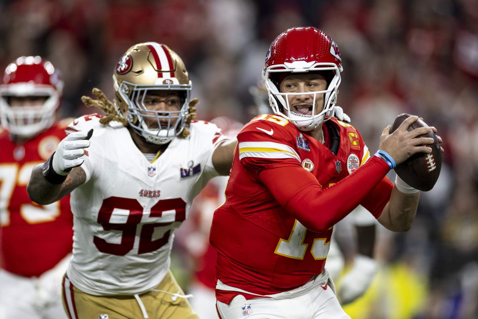 LAS VEGAS, NEVADA - FEBRUARY 11: Patrick Mahomes #15 of the Kansas City Chiefs scrambles and runs as he's tackled by Chase Young #92 of the San Francisco 49ers during the NFL Super Bowl 58 football game between the San Francisco 49ers and the Kansas City Chiefs at Allegiant Stadium on February 11, 2024 in Las Vegas, Nevada. (Photo by Michael Owens/Getty Images)