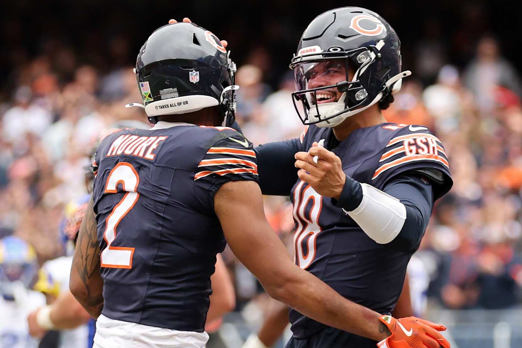 CHICAGO, ILLINOIS - SEPTEMBER 29: DJ Moore #2 and Caleb Williams #18 of the Chicago Bears celebrate after their touchdown connection against the Los Angeles Rams during the third quarter at Soldier Field on September 29, 2024 in Chicago, Illinois. (Photo by Michael Reaves/Getty Images)