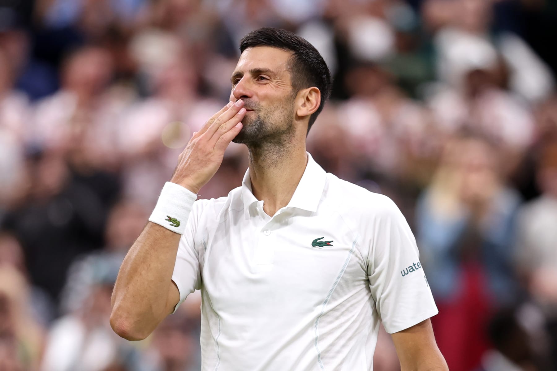 LONDON, ENGLAND - JULY 08: Novak Djokovic of Serbia blows a kiss as he celebrates winning match point against Holger Rune of Denmark in his Gentlemen's Singles fourth round match during day eight of The Championships Wimbledon 2024 at All England Lawn Tennis and Croquet Club on July 08, 2024 in London, England. (Photo by Julian Finney/Getty Images)