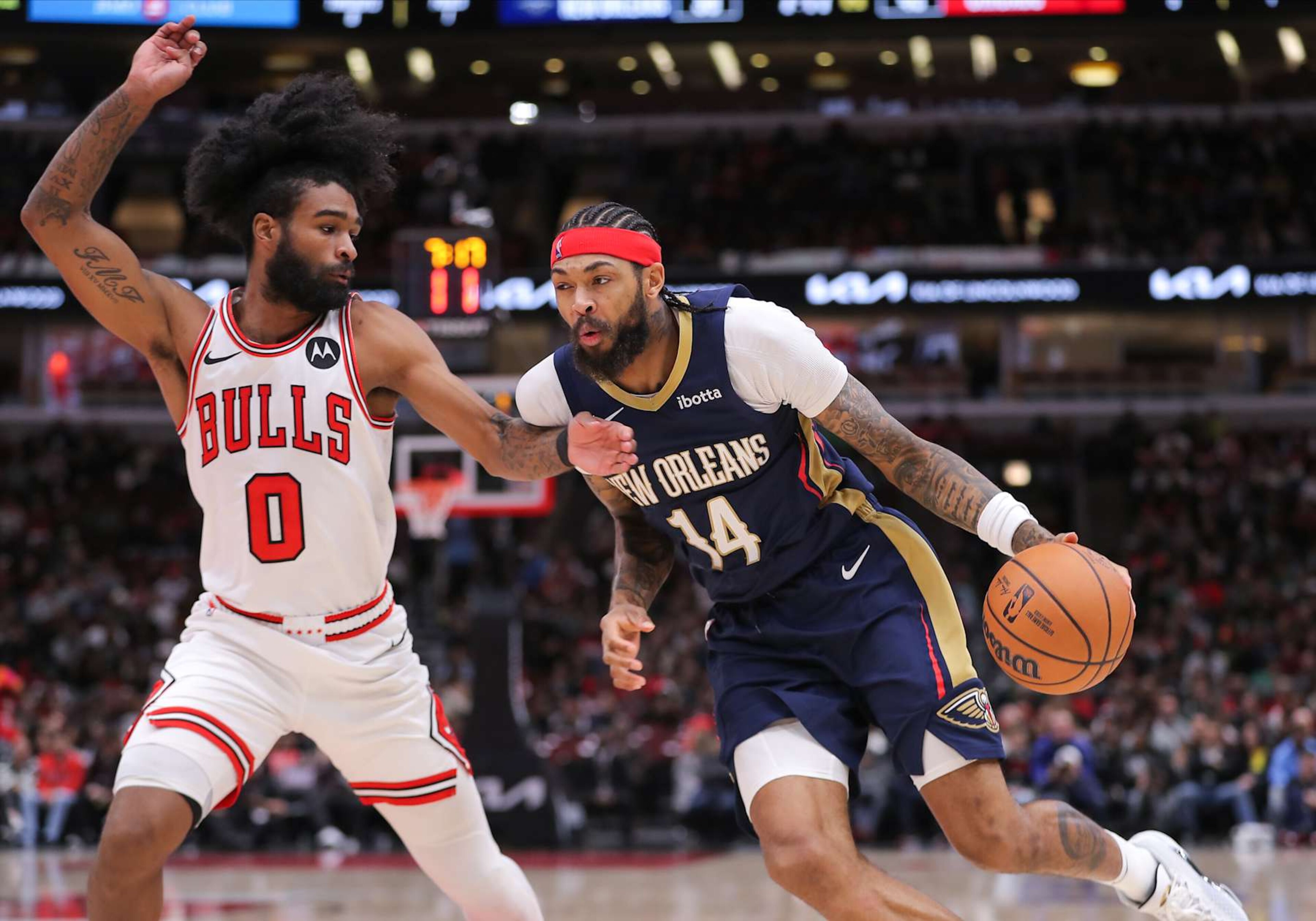 CHICAGO, IL - DECEMBER 02: Coby White #0 of the Chicago Bulls guards Brandon Ingram #14 of the New Orleans Pelicans during the first half at the United Center on December 2, 2023 in Chicago, Illinois. (Photo by Melissa Tamez/Icon Sportswire via Getty Images)