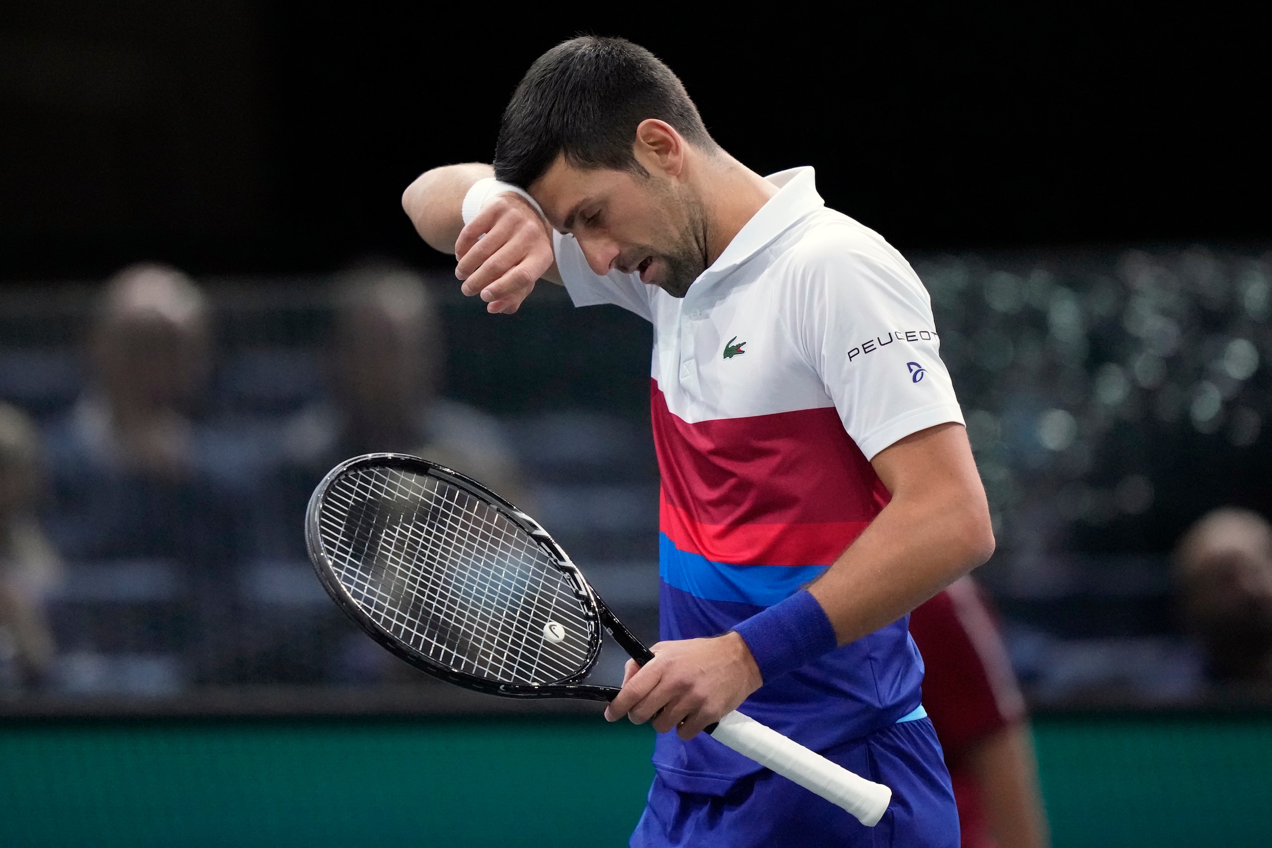 Novak Djokovic of Serbia reacts after missing a ball against U.S. Taylor Fritz during their quarterfinal match at the Paris Masters tennis tournament at the Accor Arena, in Paris, France, Friday, Nov. 5, 2021. (AP Photo/Francois Mori)