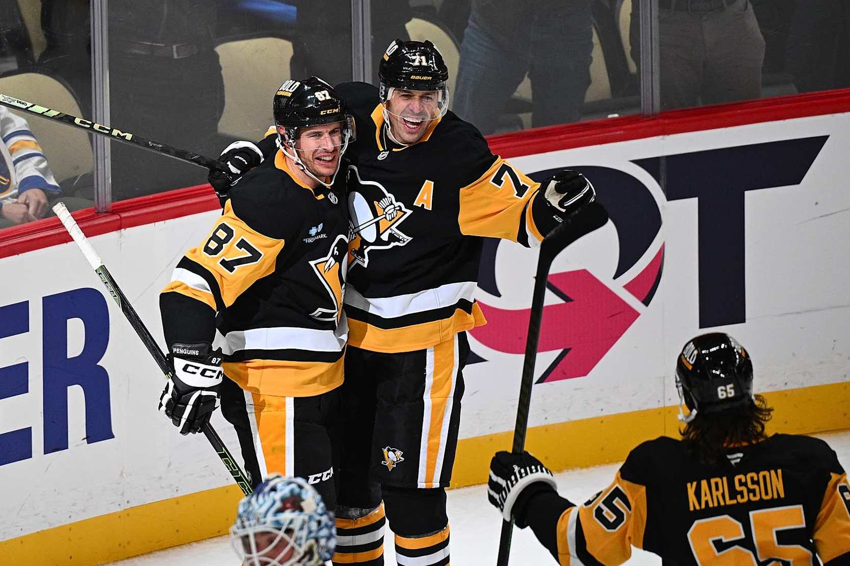 PITTSBURGH, PENNSYLVANIA - OCTOBER 16: Sidney Crosby #87 of the Pittsburgh Penguins celebrates with Evgeni Malkin #71 after scoring the game winning goal in overtime to give the Penguins a 6-5 win over the Buffalo Sabres at PPG PAINTS Arena on October 16, 2024 in Pittsburgh, Pennsylvania. (Photo by Justin Berl/Getty Images)
