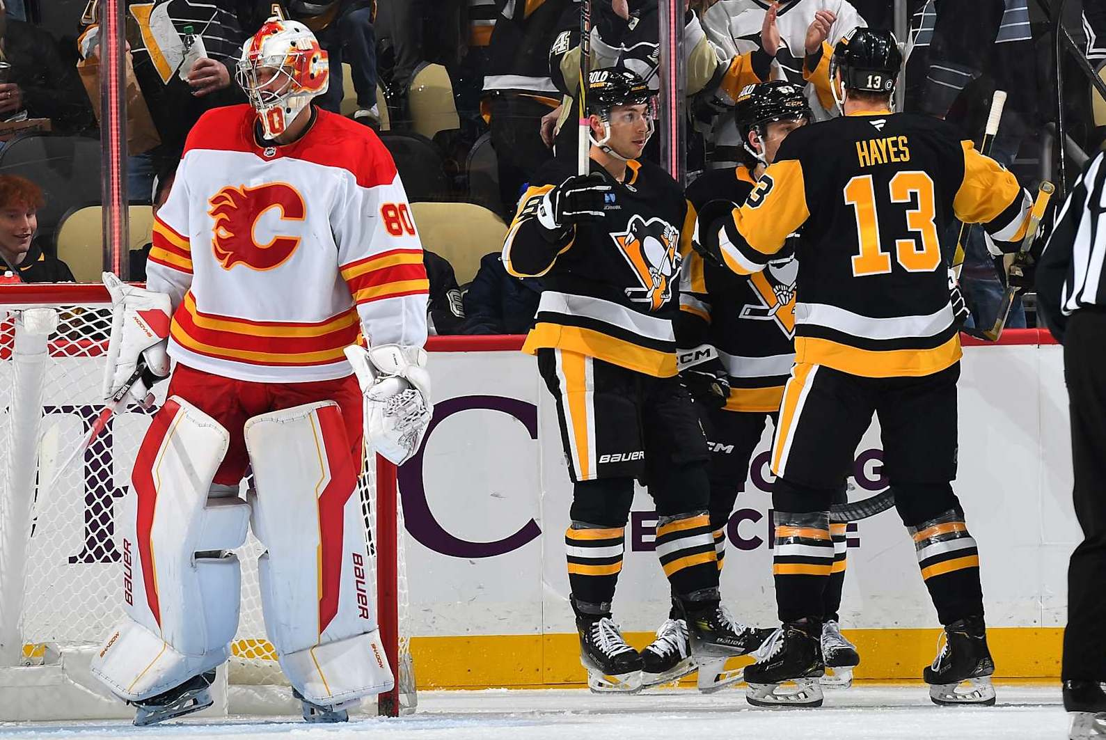 PITTSBURGH, PA - NOVEMBER 30: Michael Bunting #8 celebrates his goal with Kevin Hayes #13 and Philip Tomasino #53 of the Pittsburgh Penguins during the second period against the Calgary Flames at PPG PAINTS Arena on November 30, 2024 in Pittsburgh, Pennsylvania. (Photo by Joe Sargent/NHLI via Getty Images)