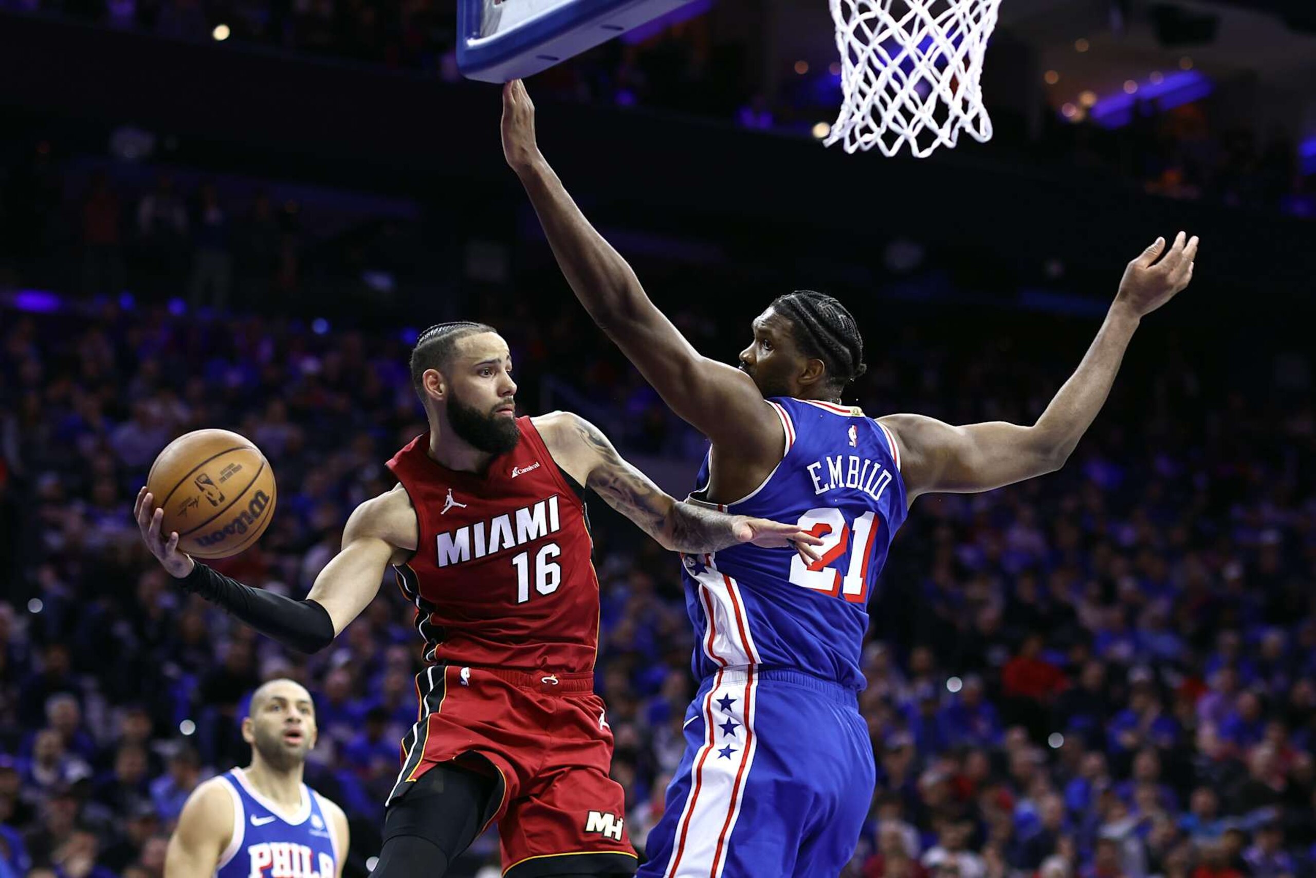 PHILADELPHIA, PENNSYLVANIA - APRIL 17: Caleb Martin #16 of the Miami Heat passes the ball past Joel Embiid #21 of the Philadelphia 76ers during the third quarter of the Eastern Conference Play-In Tournament at the Wells Fargo Center on April 17, 2024 in Philadelphia, Pennsylvania. NOTE TO USER: User expressly acknowledges and agrees that, by downloading and or using this photograph, User is consenting to the terms and conditions of the Getty Images License Agreement. (Photo by Tim Nwachukwu/Getty Images) PHILADELPHIA, PENNSYLVANIA - APRIL 17: Caleb Martin #16 of the Miami Heat passes the ball past Joel Embiid #21 of the Philadelphia 76ers during the third quarter of the Eastern Conference Play-In Tournament at the Wells Fargo Center on April 17, 2024 in Philadelphia, Pennsylvania. NOTE TO USER: User expressly acknowledges and agrees that, by downloading and or using this photograph, User is consenting to the terms and conditions of the Getty Images License Agreement. (Photo by Tim Nwachukwu/Getty Images)