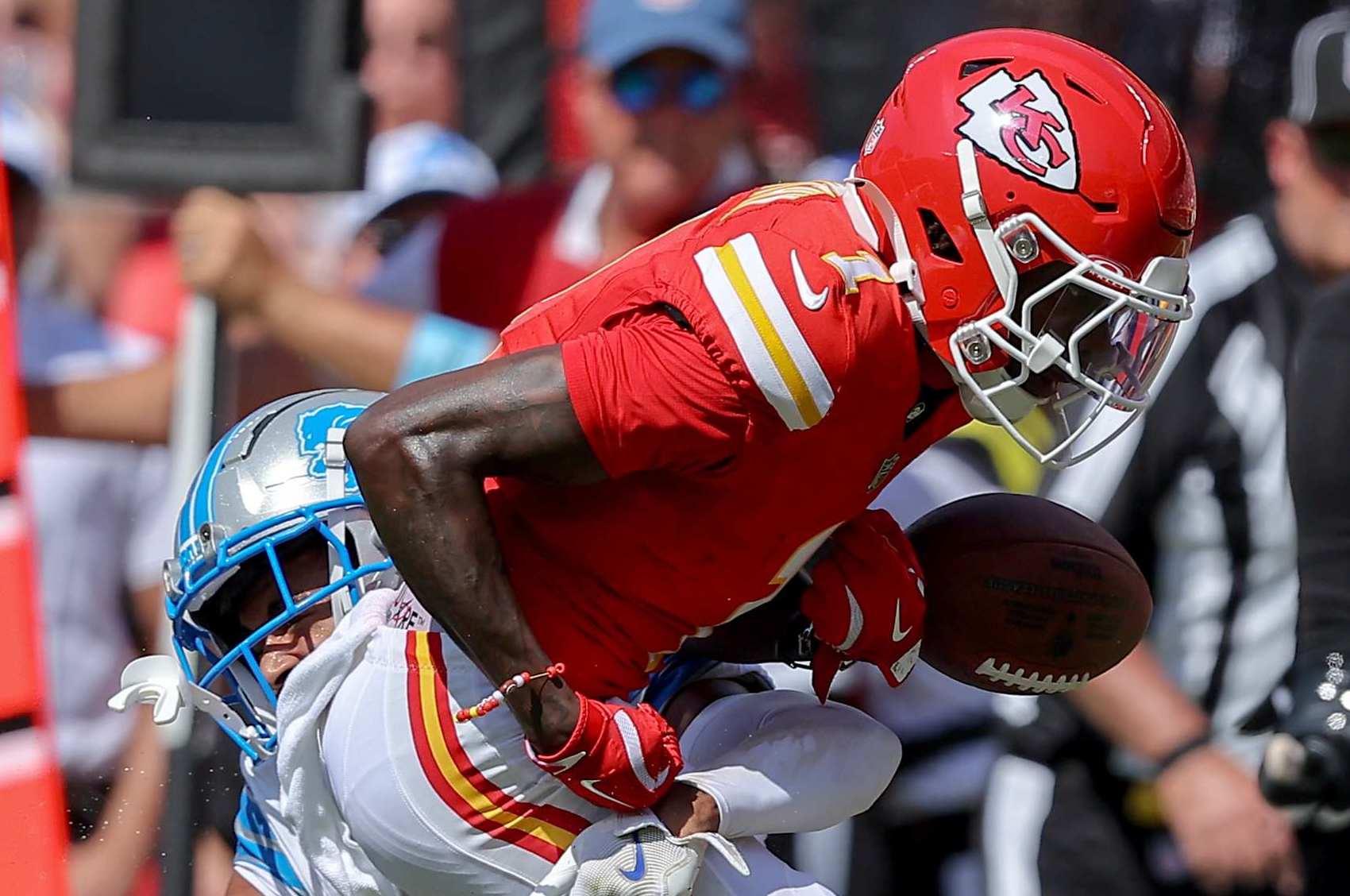 KANSAS CITY, MISSOURI - AUGUST 17: Xavier Worthy #1 of the Kansas City Chiefs fumbles the football during a tackle by Brandon Joseph #40 of the Detroit Lions in the first quarter of a preseason game at GEHA Field at Arrowhead Stadium on August 17, 2024 in Kansas City, Missouri. (Photo by David Eulitt/Getty Images)