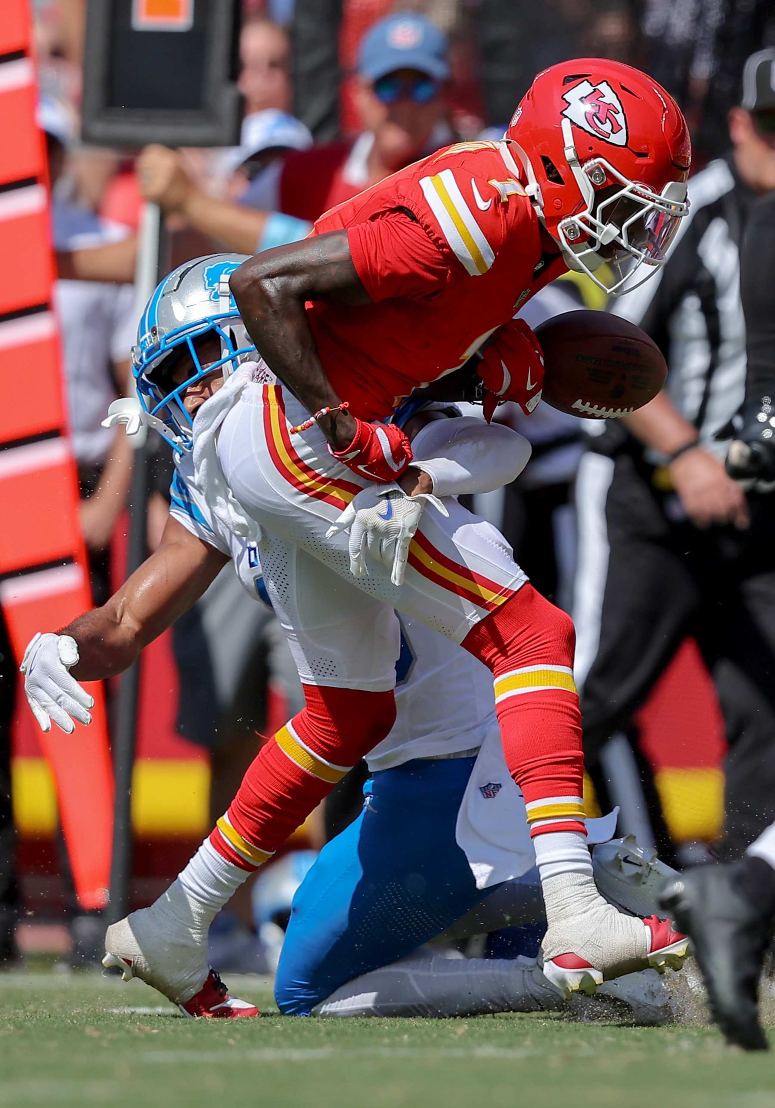 KANSAS CITY, MISSOURI - AUGUST 17: Xavier Worthy #1 of the Kansas City Chiefs fumbles the football during a tackle by Brandon Joseph #40 of the Detroit Lions in the first quarter of a preseason game at GEHA Field at Arrowhead Stadium on August 17, 2024 in Kansas City, Missouri. (Photo by David Eulitt/Getty Images)