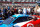 Crowds surround a Daytona Prototype on pit road just before the start of the Rolex 24