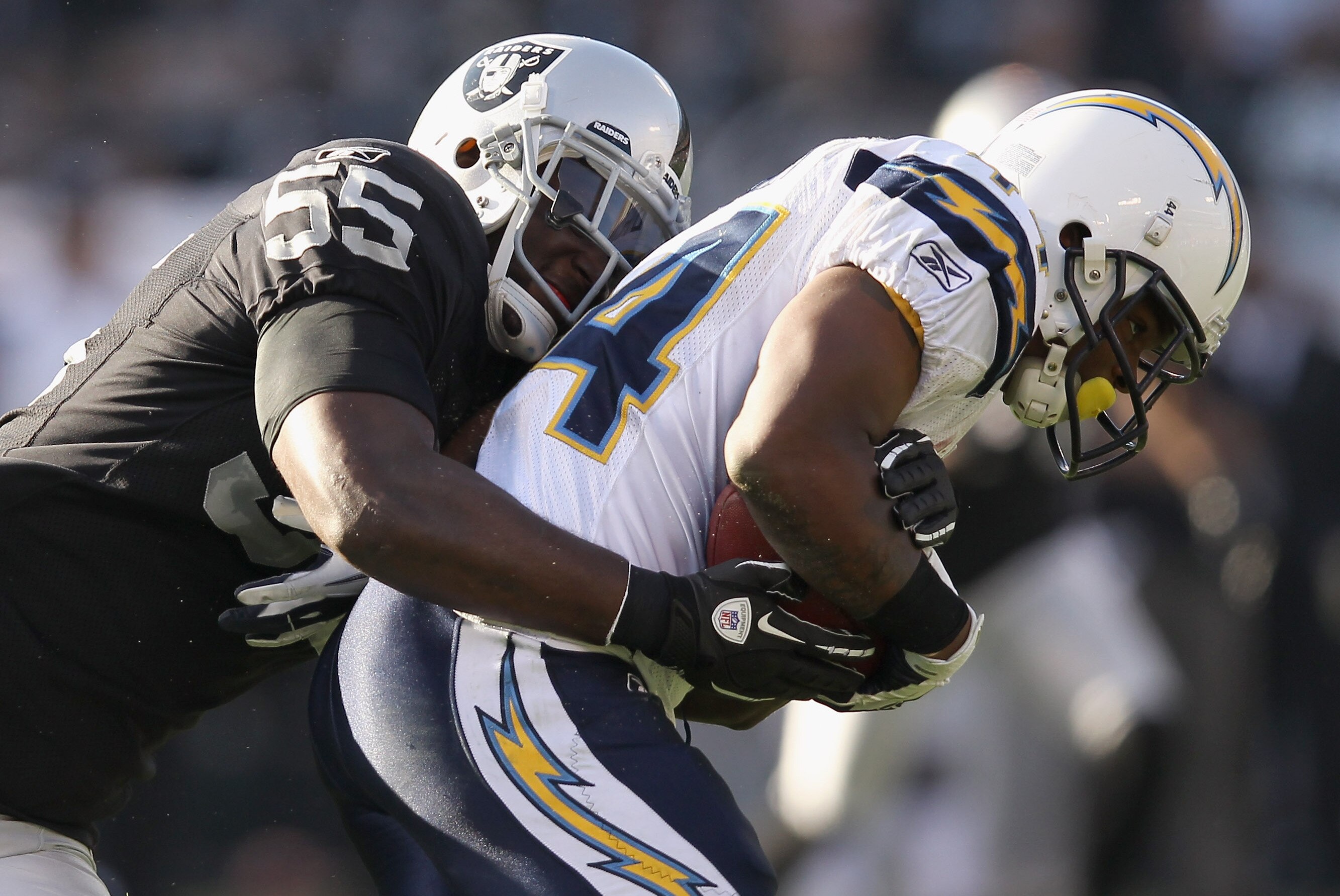OAKLAND, CA - JANUARY 01: Curtis Brinkley #44 of the San Diego Chargers is tackled by Rolando McClain #55 of the Oakland Raiders at O.co Coliseum on January 1, 2012 in Oakland, California. (Photo by Ezra Shaw/Getty Images)