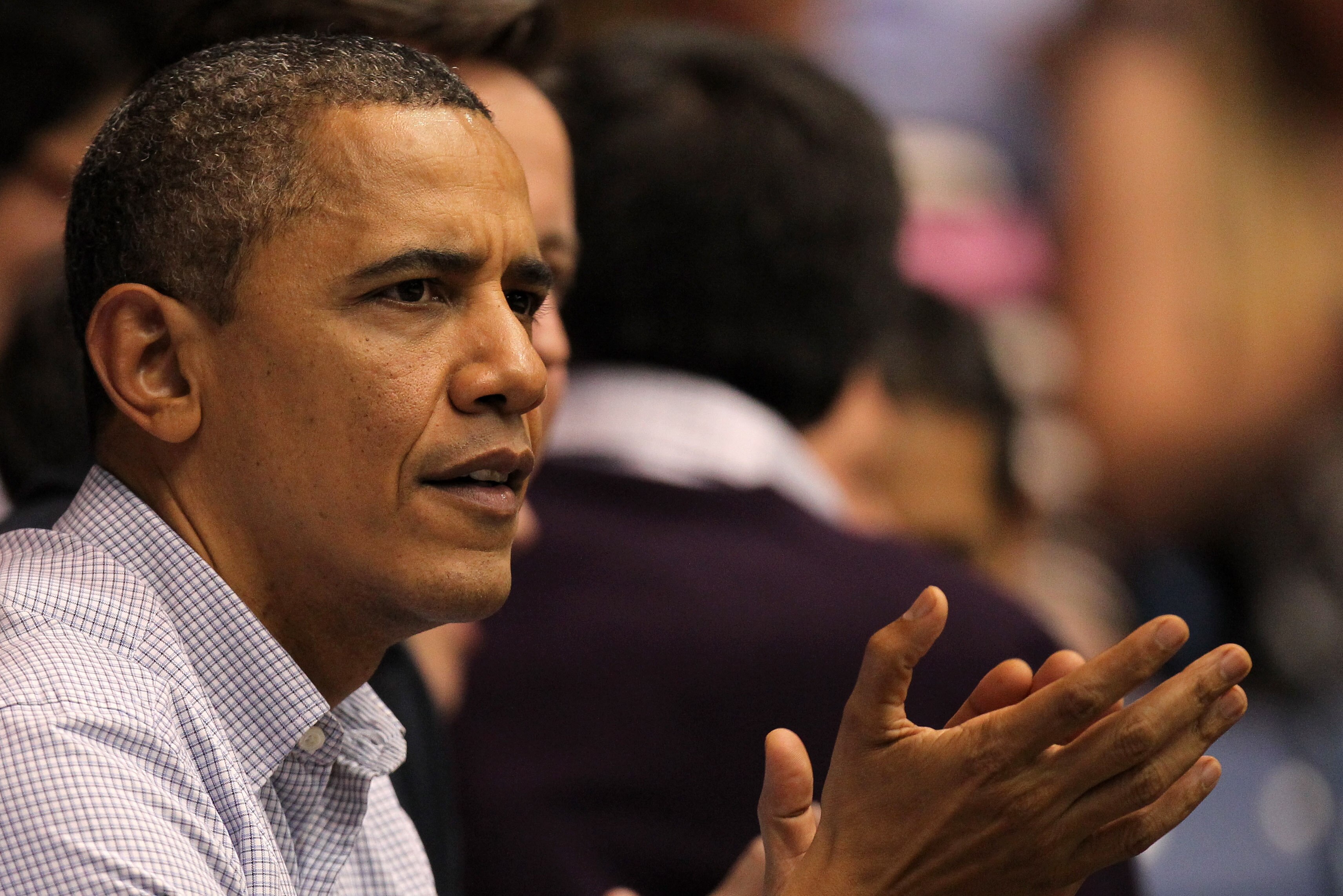 DAYTON, OH - MARCH 13:  U.S. President Barack Obama claps as he sits with British Prime Minister David Cameron (unseen) at UD Arena to watch the Western Kentucky Hilltoppers take on the Mississippi Valley State Delta Devils in the first round of the 2011 NCAA men's basketball tournament on March 13, 2012 in Dayton, Ohio.  (Photo by Gregory Shamus/Getty Images)