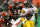 CINCINNATI - DECEMBER 31:  Santonio Holmes #10 of the Pittsburgh Steelers eludes Madieu Williams #40 of the Cincinnati Bengals en route to a touchdown in overtime on December 31, 2006 at Paul Brown Stadium in Cincinnati, Ohio. The Steelers defeated the Bengals 23-17.  (Photo by Matthew Stockman/Getty Images)