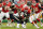KANSAS CITY, MO - OCTOBER 22:  Defensive end Tamba Hali #91 of the Kansas City Chiefs wraps up running back LaDanian Tomlinson #21 of the San Diego Chargers for a three yard loss in the first quarter October 22, 2006 at Arrowhead Stadium in Kansas City, Missouri.  (Photo by Brian Bahr/Getty Images)