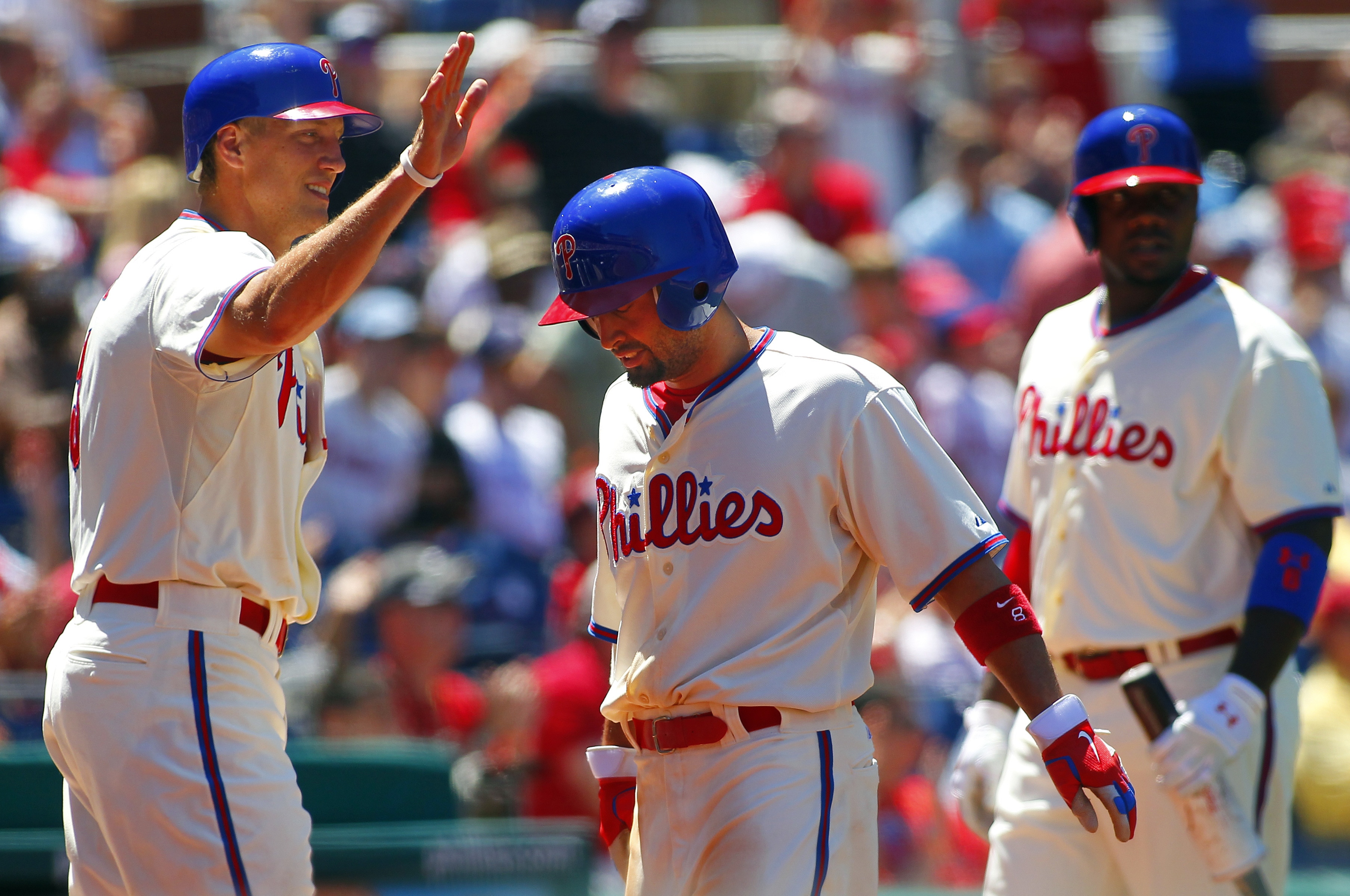 PHILADELPHIA, PA - JULY 25: Shane Victorino #8 of the Philadelphia Phillies is congratulated by Hunter Pence #3 after scoring on a double by Chase Utley #26 (not pictured) against of the Milwaukee Brewers during a MLB baseball game on July 25, 2012 at Citizens Bank Park in Philadelphia, Pennsylvania. (Photo by Rich Schultz/Getty Images)