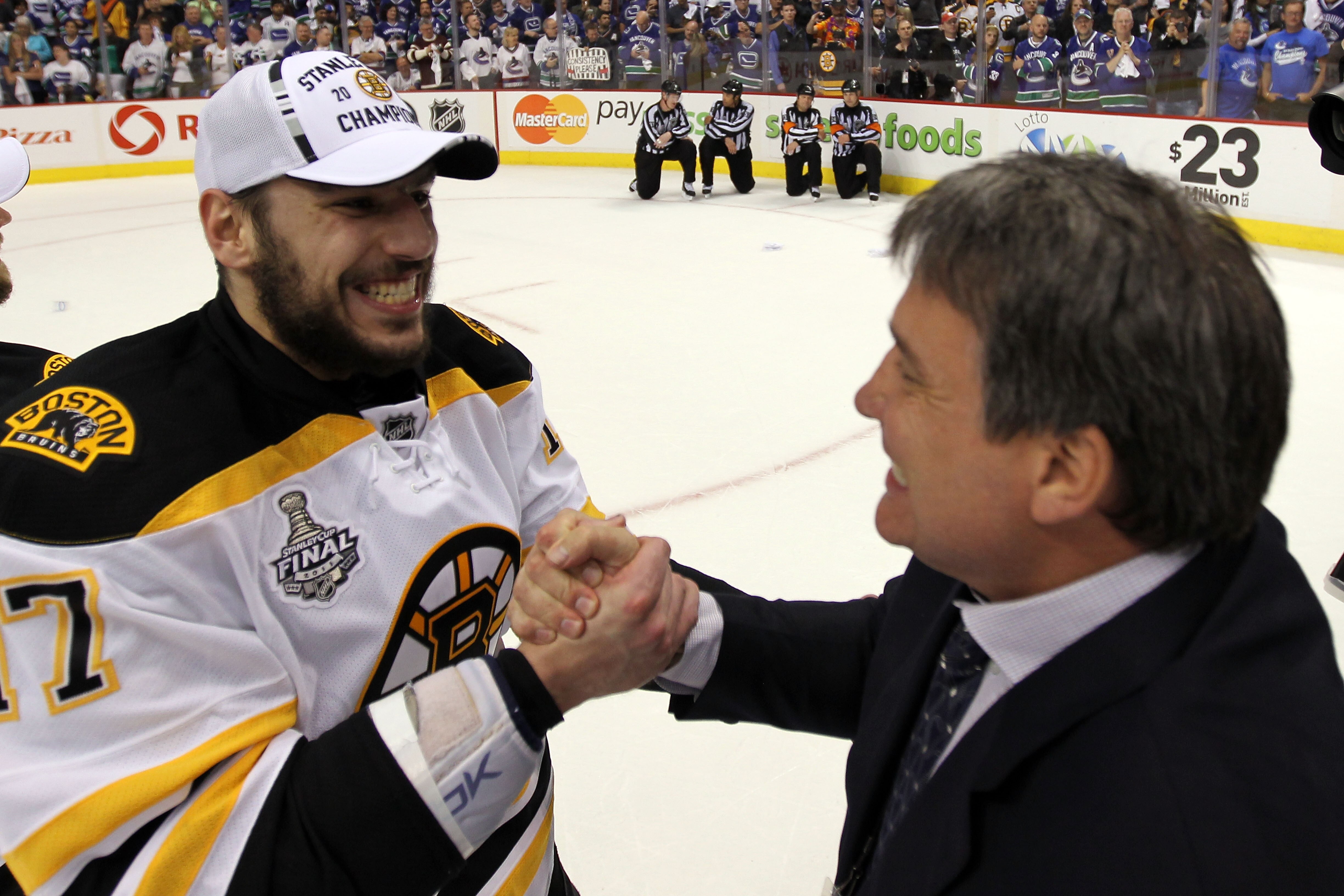 VANCOUVER, BC - JUNE 15: Milan Lucic (L) #17 and the Boston Bruins president Cam Neely (R) celebrate after defeating the Vancouver Canucks in Game Seven of the 2011 NHL Stanley Cup Final at Rogers Arena on June 15, 2011 in Vancouver, British Columbia, Canada. The Boston Bruins defeated the Vancouver Canucks 4 to 0. (Photo by Bruce Bennett/Getty Images)