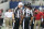 Sep 23, 2012; Arlington, TX, USA; Replacement referee Robert Dalton (22) talks with back judge Bobby Jackson (56) and side judge Jeff Garvin (38) for a penalty flag during the game with the Dallas Cowboys against the Tampa Bay Buccaneers at Cowboys Stadium. Mandatory Credit: Matthew Emmons-US PRESSWIRE