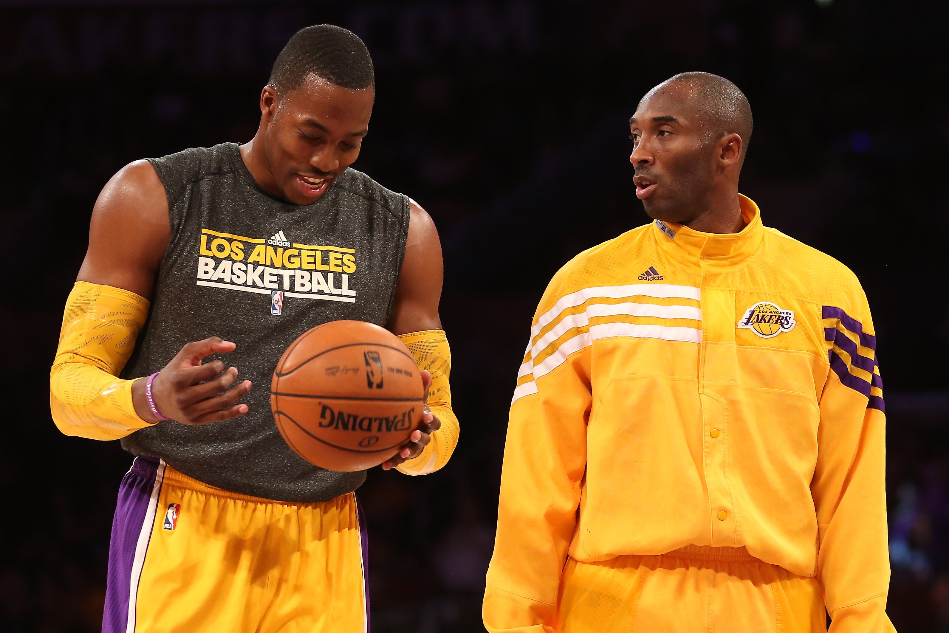 LOS ANGELES, CA - OCTOBER 21: Dwight Howard #12 (L) and Kobe Bryant #24 of the Los Angeles Lakers talks as they warm up to play the Sacramento Kings at Staples Center on October 21, 2012 in Los Angeles, California. NOTE TO USER: User expressly acknowledges and agrees that, by downloading and or using this photograph, User is consenting to the terms and conditions of the Getty Images License Agreement. (Photo by Stephen Dunn/Getty Images)