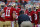 SAN FRANCISCO, CA - OCTOBER 18:  Head coach Jim Harbaugh of the San Francisco 49ers calls a play in the huddle before a game against the Seattle Seahawks on October 18, 2012 at Candlestick Park in San Francisco, California.  The 49ers won 13-6.  (Photo by Brian Bahr/Getty Images)