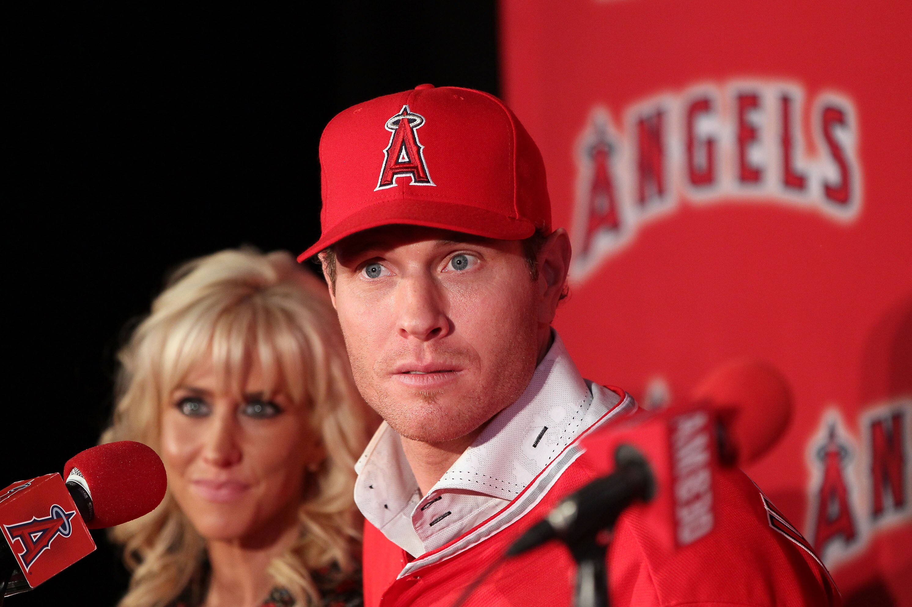 ANAHEIM, CA - DECEMBER 15: Josh Hamilton #32 of the Los Angeles Angels of Anaheim listens to a question from the media as wife Katie looks on during the press conference introducing Hamilton as the team's newest member at ESPN Zone at Downtown Disney on December 15, 2012 in Anaheim, California. (Photo by Victor Decolongon/Getty Images)