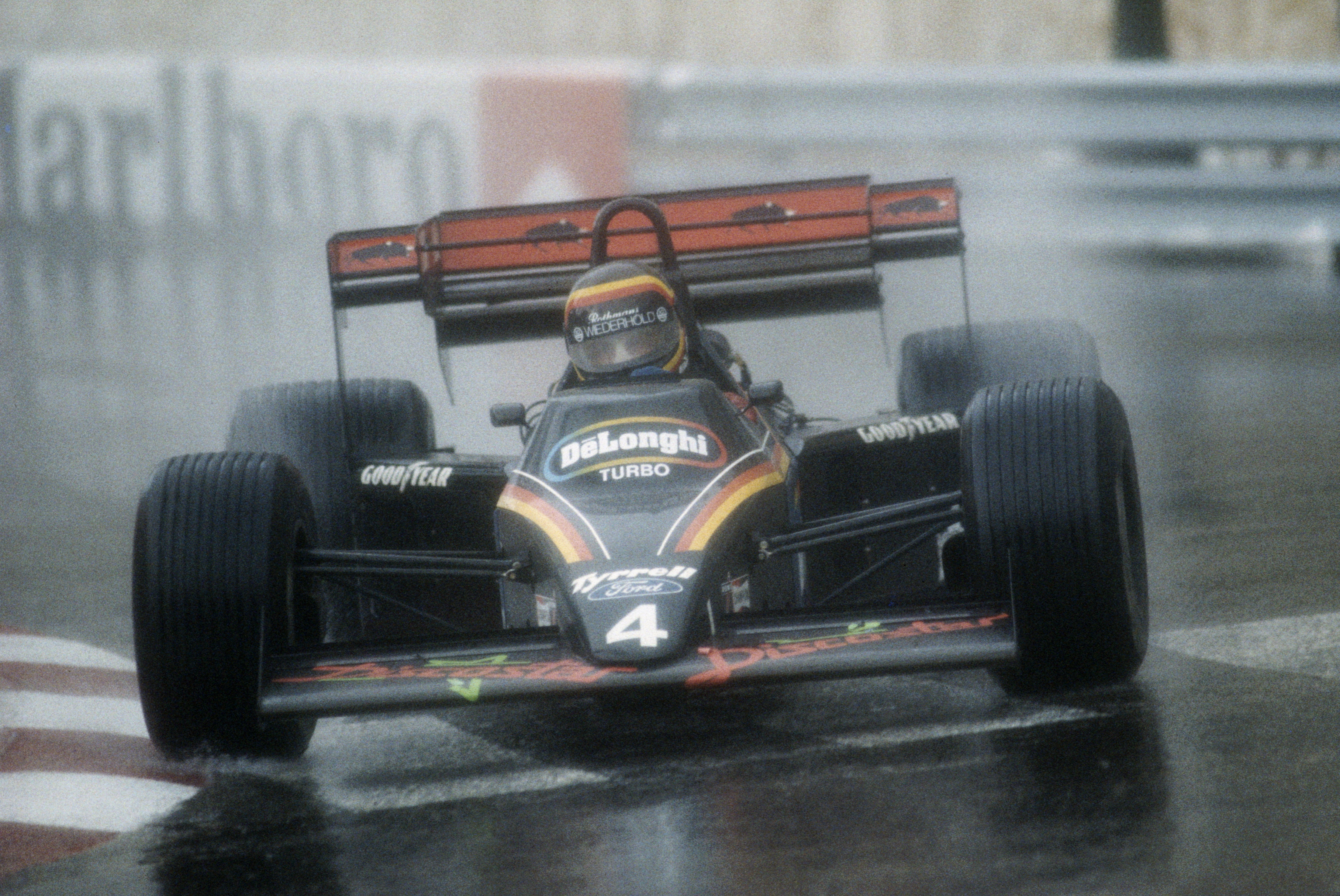 Stefan Bellof drives the #4 Team Tyrrell-Ford 012 in the rain during the Grand Prix of Monaco on 3 June 1984 on the streets of the Principality of Monaco in Monte Carlo, Monaco.Despite finishing third Bellof was later disqualified for a technical infringement. (Photo by Mike Powell/Getty Images)