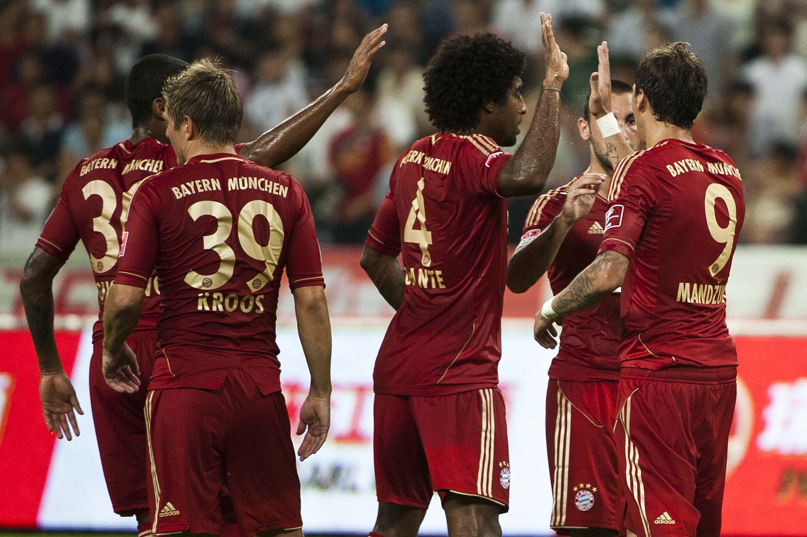 GUANGZHOU, GUANGDONG - JULY 26: Mario Mandzukic of Bayern Munich celebrates with team mates after scoring during a friendly match against VfL Wolfsburg as part of the Audi Football Summit 2012 on July 26, 2012 at the Guangdong Olympic Sports Center in Guangzhou, China. (Photo by Victor Fraile/Getty Images)