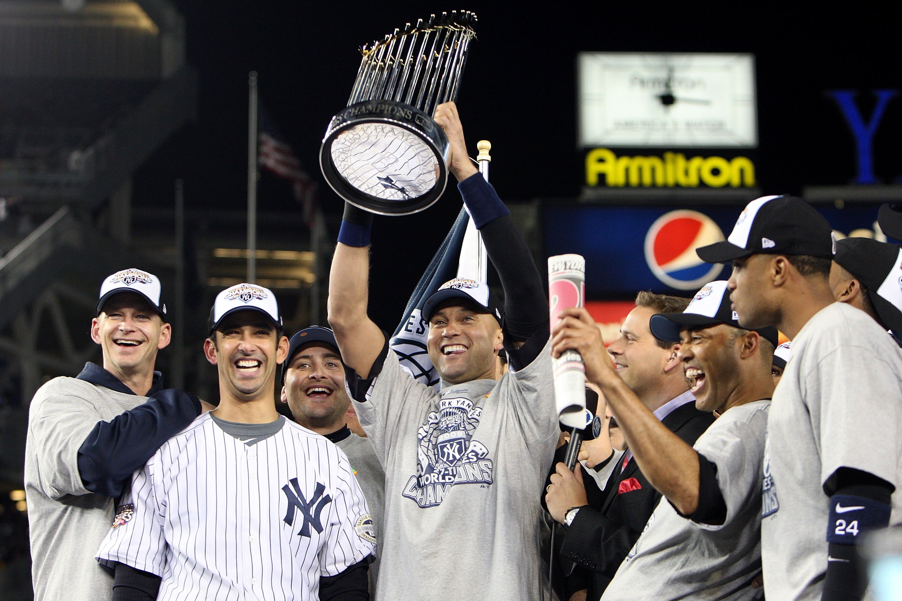 NEW YORK - NOVEMBER 04: Derek Jeter #2 of the New York Yankees holds up the trophy as he celebrates with A.J. Burnett (L), Jorge Posada (2nd L), Mariano Rivera (2nd R) and Robinson Cano after their 7-3 win against the Philadelphia Phillies in Game Six of the 2009 MLB World Series at Yankee Stadium on November 4, 2009 in the Bronx borough of New York City. (Photo by Jed Jacobsohn/Getty Images)