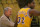 Guard Earvin (Magic) Johnson of the Los Angeles Lakers looks on with Lakers owner Jerry Boss during a game.