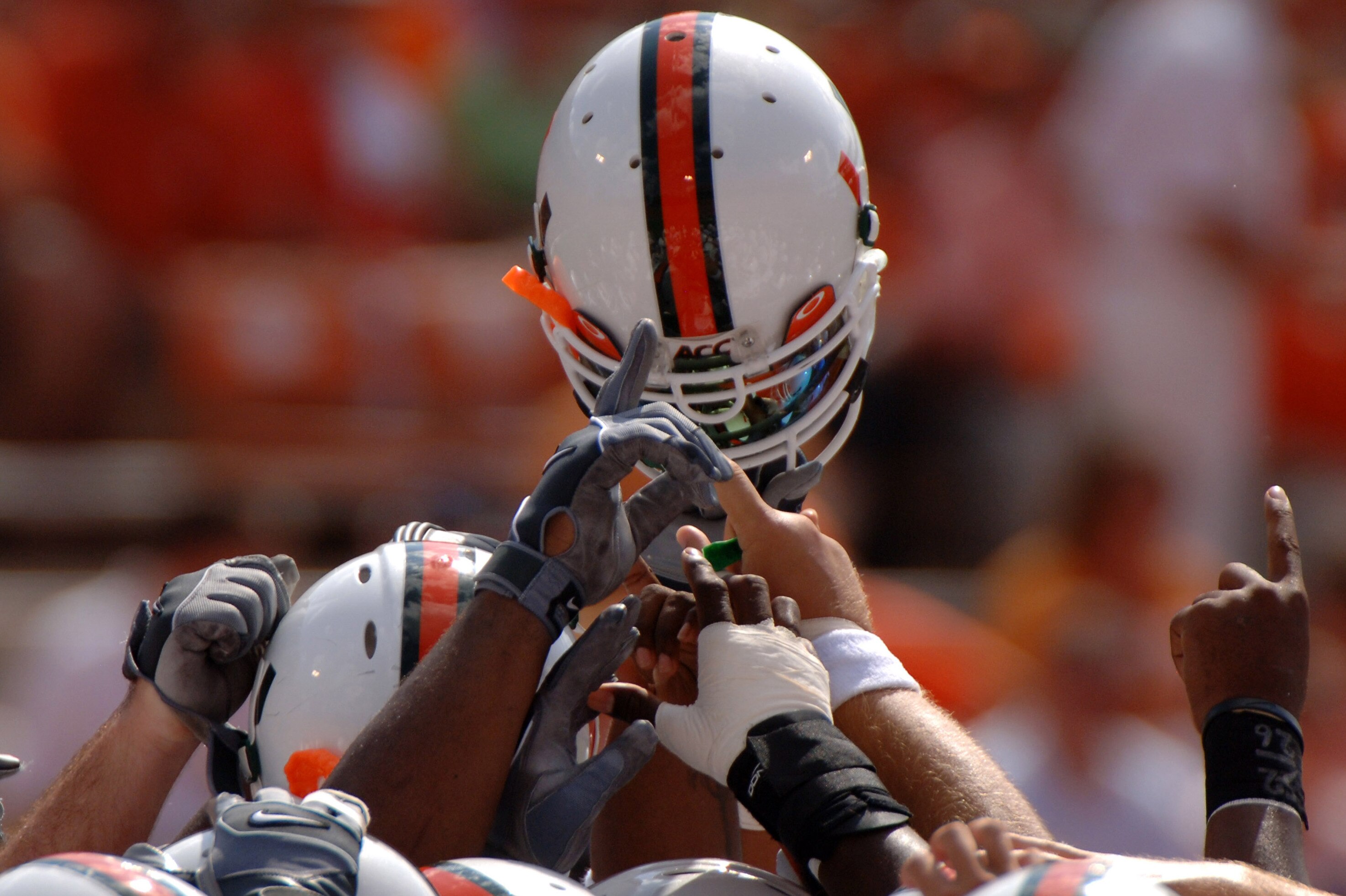 University of Miami huddle with helmets high before play against Clemson September 17, 2005 at Clemson. (Photo by A. Messerschmidt/Getty Images) *** Local Caption ***